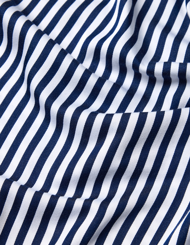 Close-up of Cozy Earth’s Bamboo Sheet Set fabric, featuring navy blue and white vertical stripes. The material is slightly wrinkled, adding gentle folds and waves to the striped pattern.