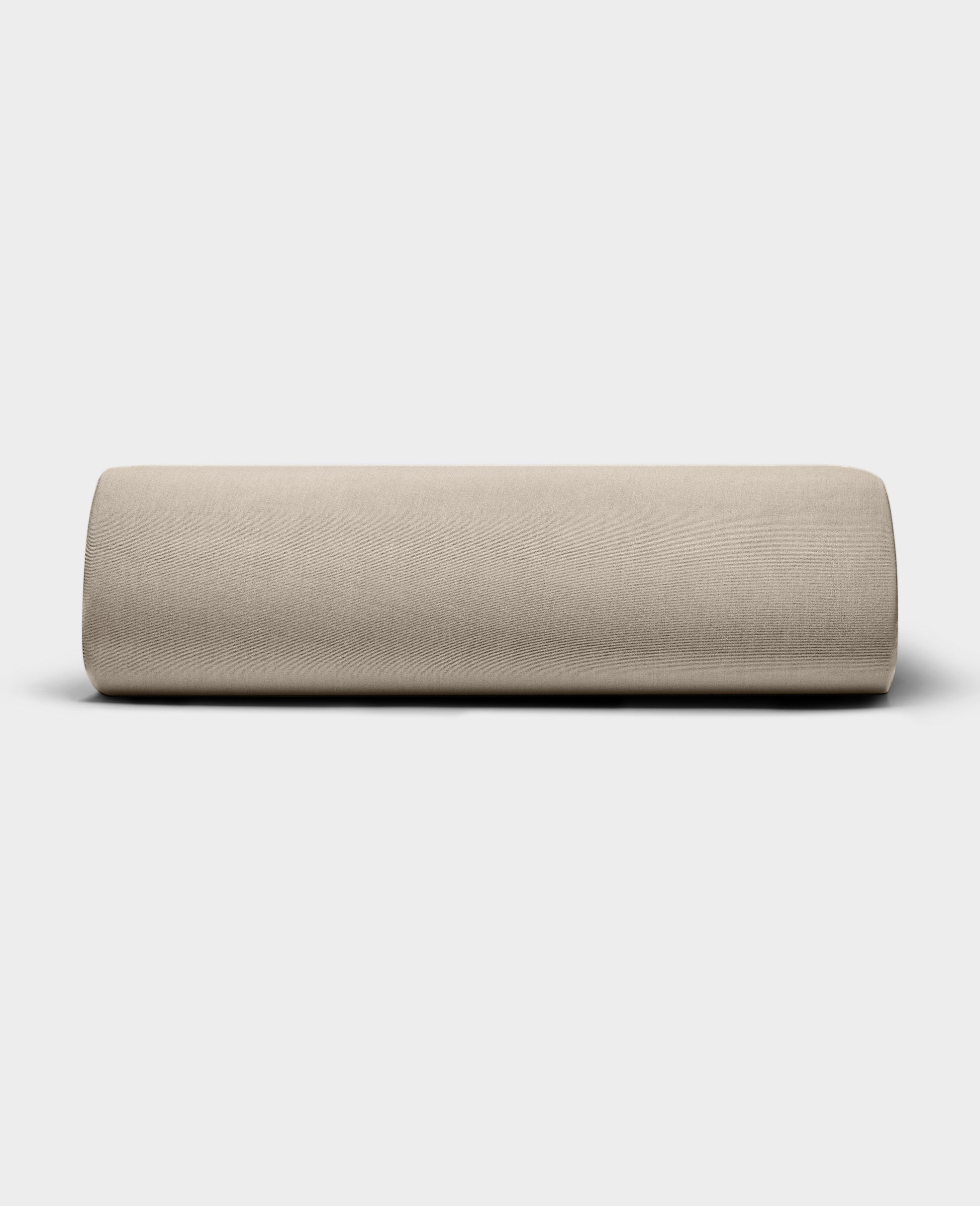 The Bamboo Jersey Fitted Sheet by Cozy Earth, shown in light beige with a smooth fabric texture, is displayed against a plain white background.|Color:Driftwood