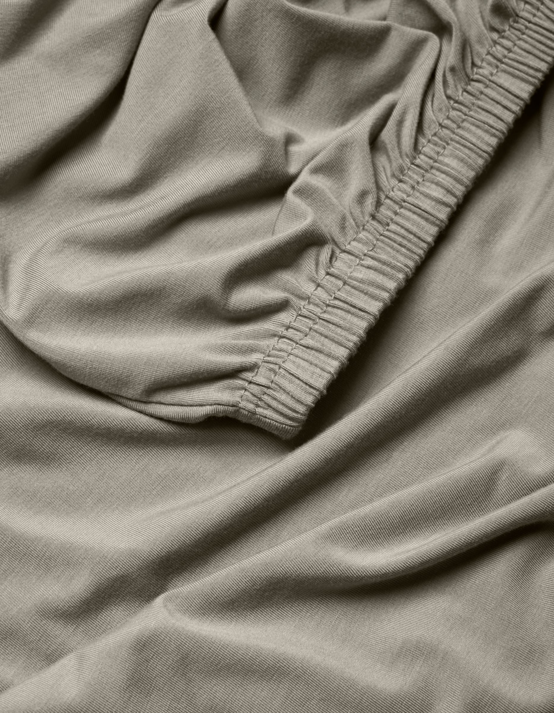 A close-up of the Cozy Earth Bamboo Jersey Fitted Sheet fabric.|Color:Stone