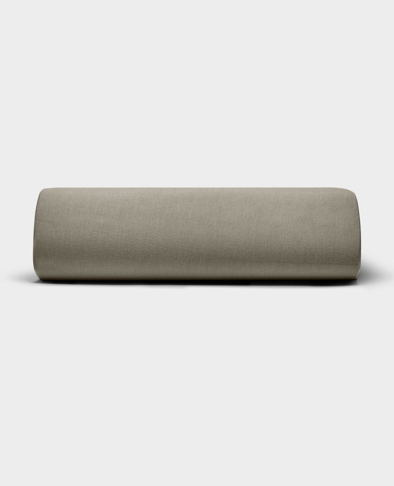 The Bamboo Jersey Fitted Sheet by Cozy Earth, shown in light beige with a smooth fabric texture, is displayed against a plain white background.