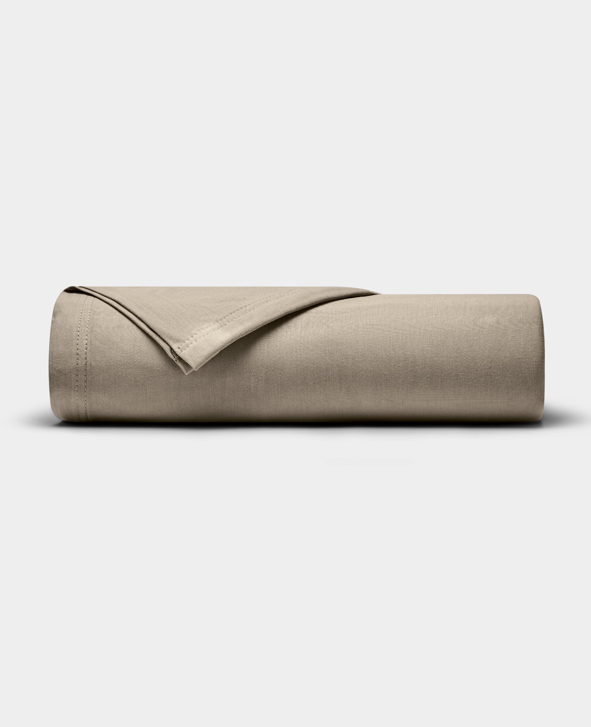A Cozy Earth Bamboo Jersey Flat Sheet in beige is neatly folded and displayed on a plain, light gray background.|Color:Driftwood