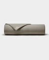 The Cozy Earth Bamboo Jersey Flat Sheet, shown neatly folded in taupe, is displayed on a plain white background.|Color:Stone
