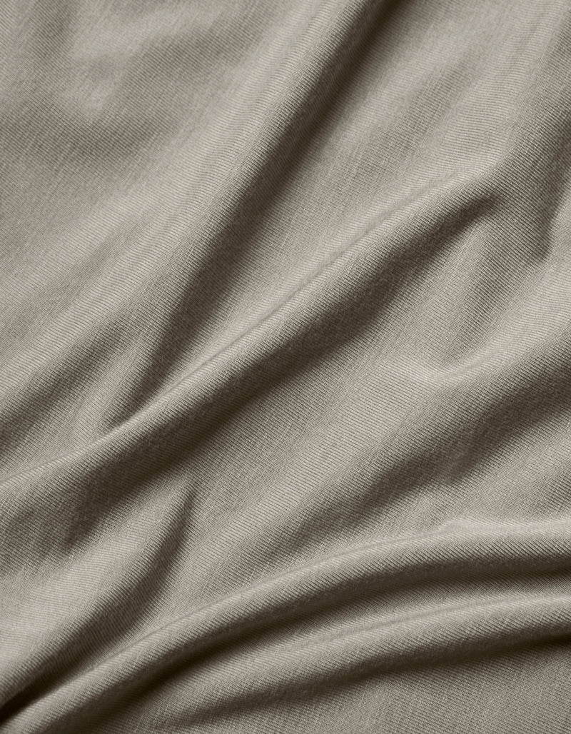 Close-up of the Cozy Earth Bamboo Jersey Flat Sheet in light grey, highlighting its smooth texture, subtle weave pattern, and soft folds.