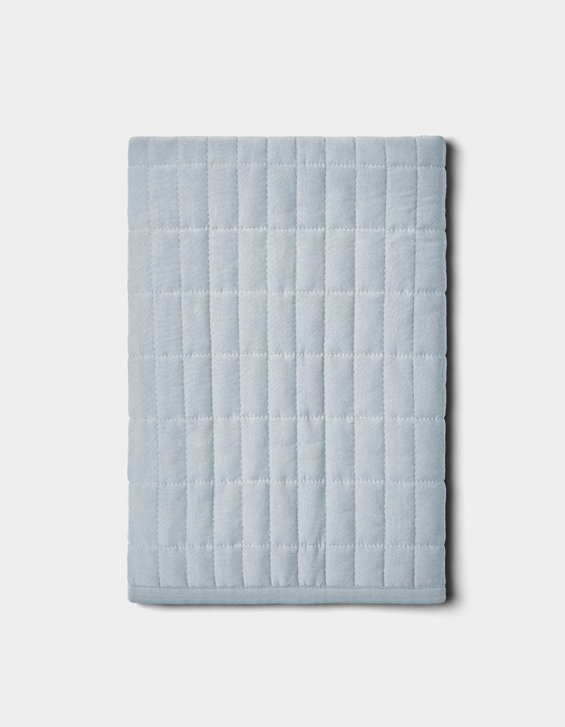 The Cozy Earth Bamboo Jersey Quilted Shams feature a folded, light gray design with a square grid pattern, shown on a plain white background.