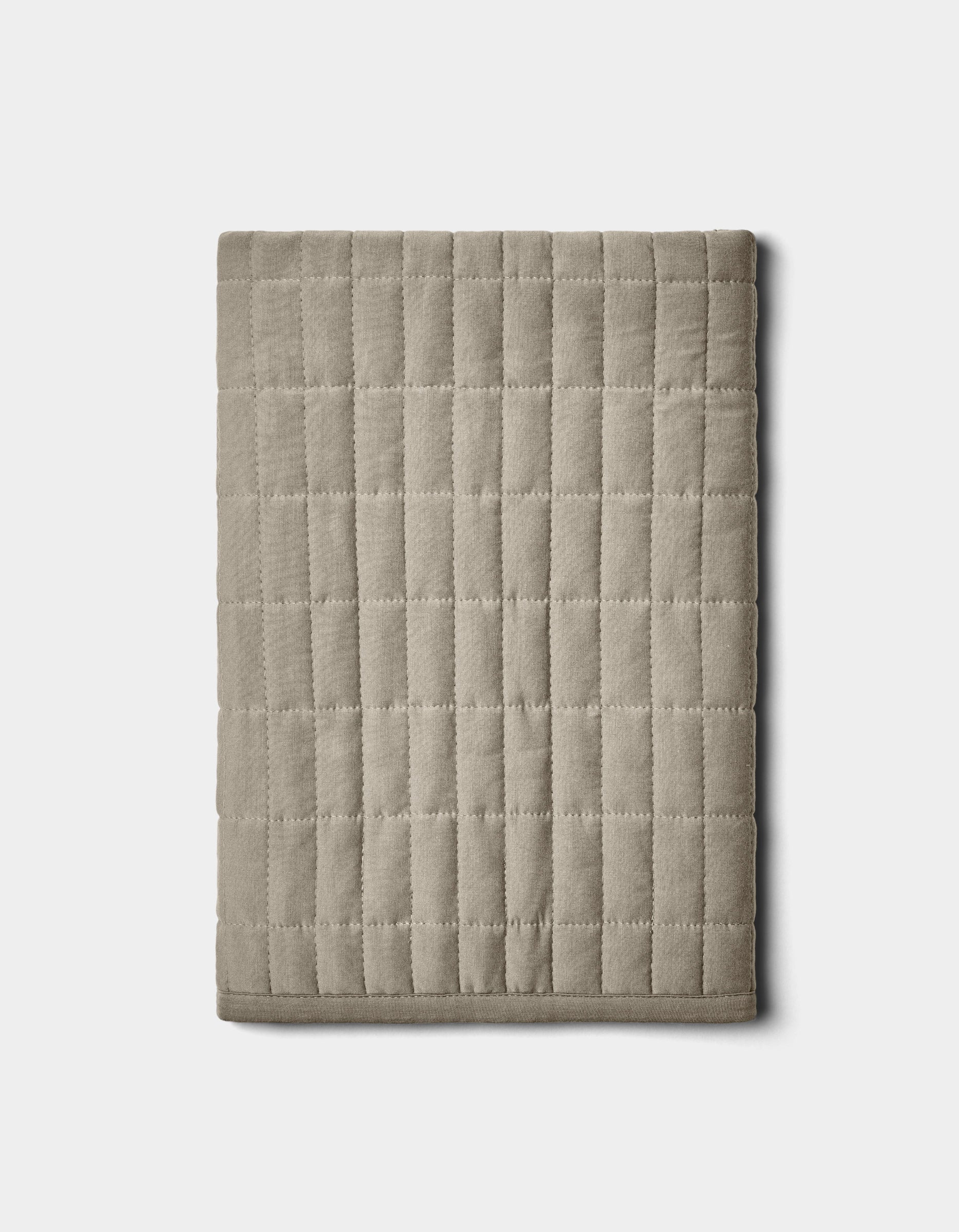 The Cozy Earth Bamboo Jersey Quilted Shams in beige feature a square grid pattern and are displayed folded on a plain white background.|Color:Stone