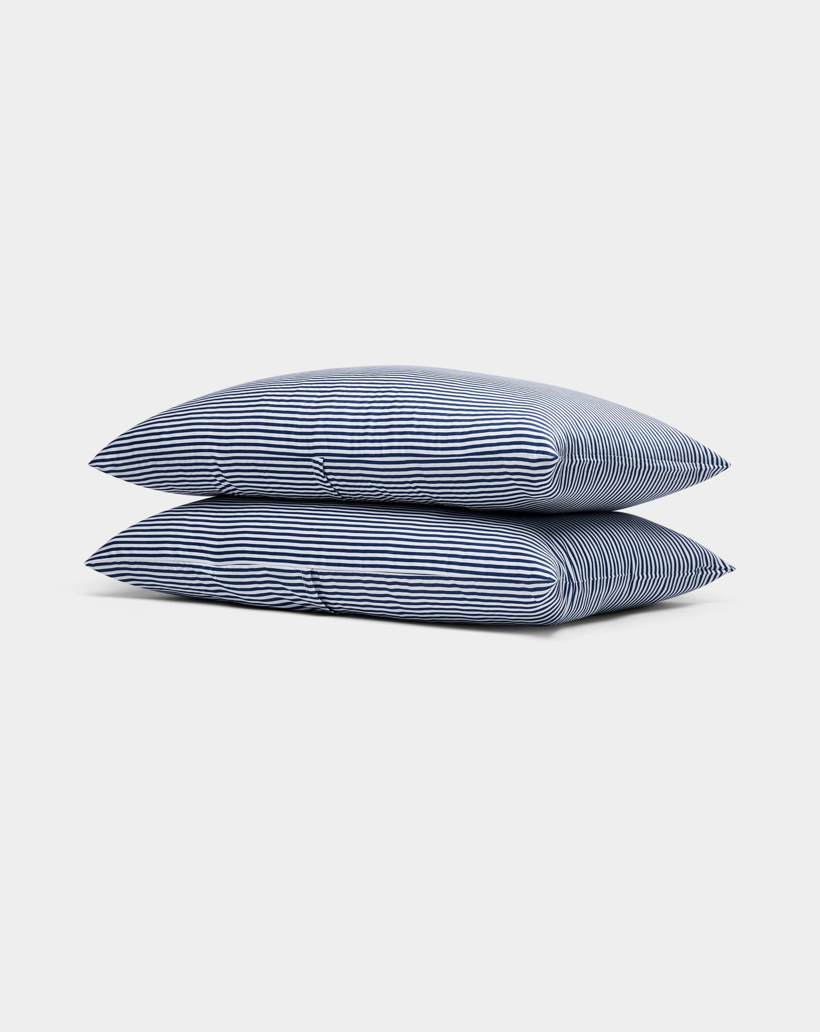 Two Cozy Earth Bamboo Pillowcases, blue-and-white striped, are stacked neatly against a plain white background.