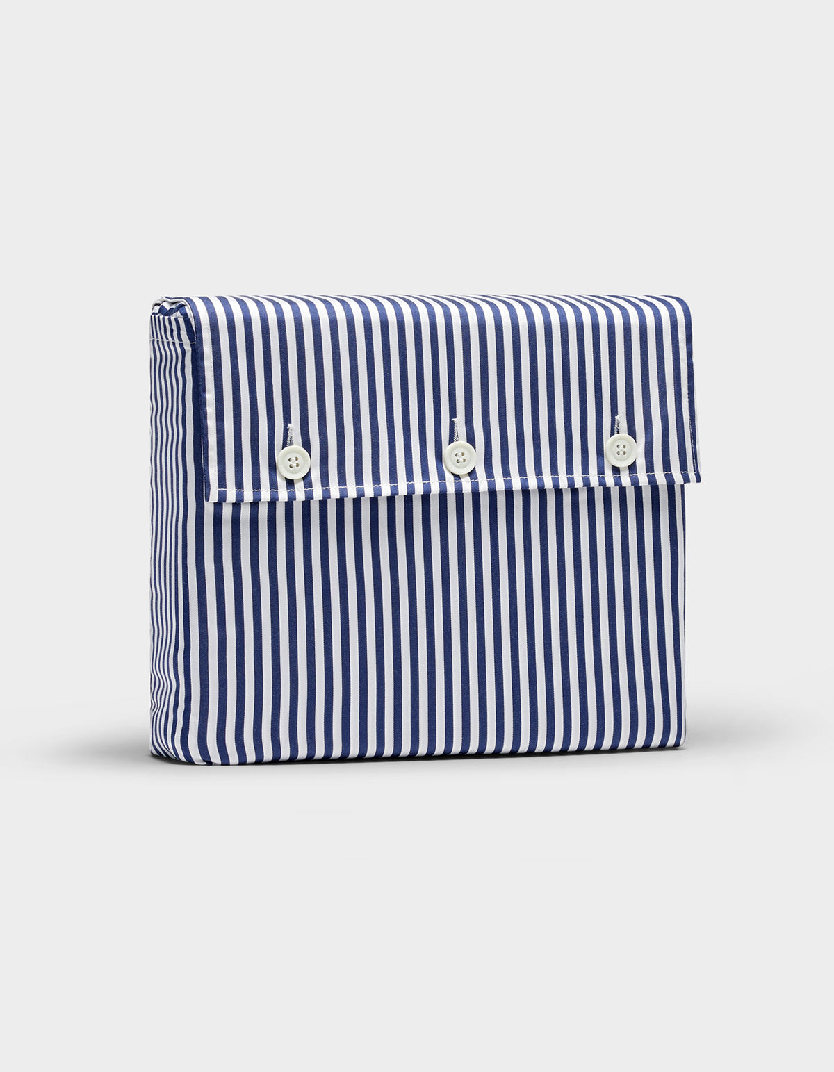 The Bamboo Sheet Set by Cozy Earth comes in a rectangular pouch with vertical blue and white stripes and a front flap secured by three white buttons.