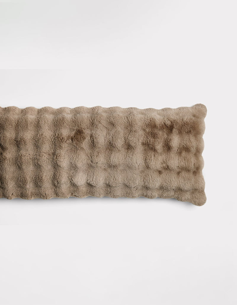 The Bubble Cuddle Pillow by Cozy Earth is a rectangular, light brown pillow with a soft, plush, furry texture, shown against a plain white background.