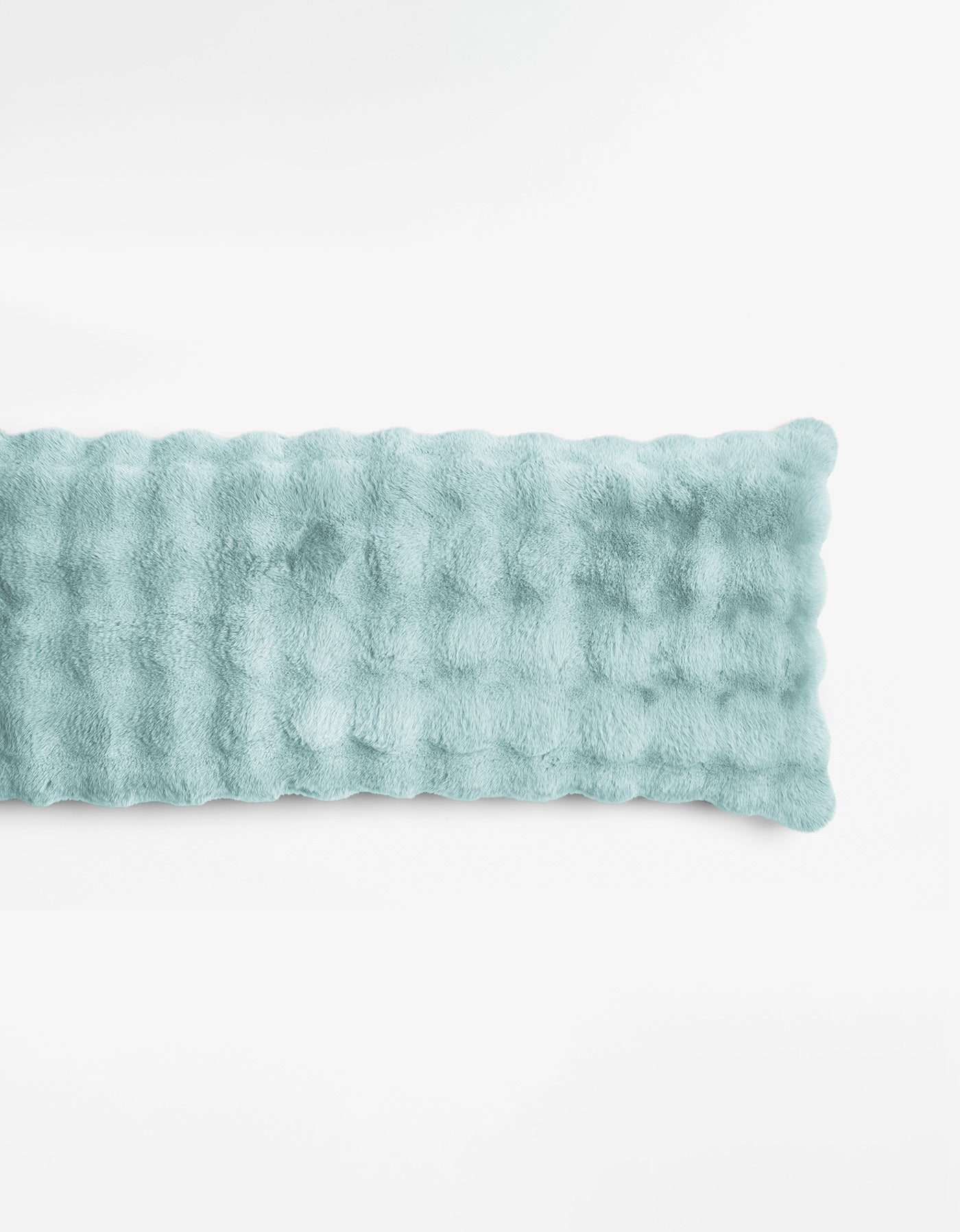 The Bubble Cuddle Pillow by Cozy Earth is a rectangular, blue-colored plush pad with a soft, furry texture, shown lying flat on a plain white background.
