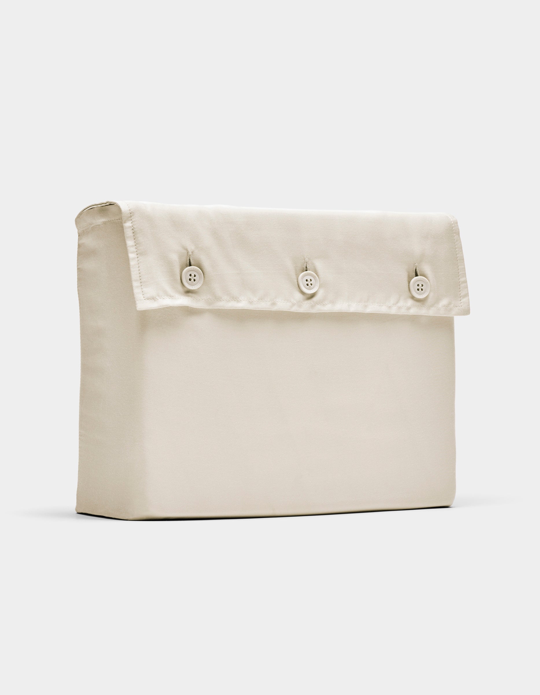 The Bamboo Sheet Set by Cozy Earth, shown upright against a plain white background, features a rectangular beige fabric pouch with a flap closure secured by three white buttons.