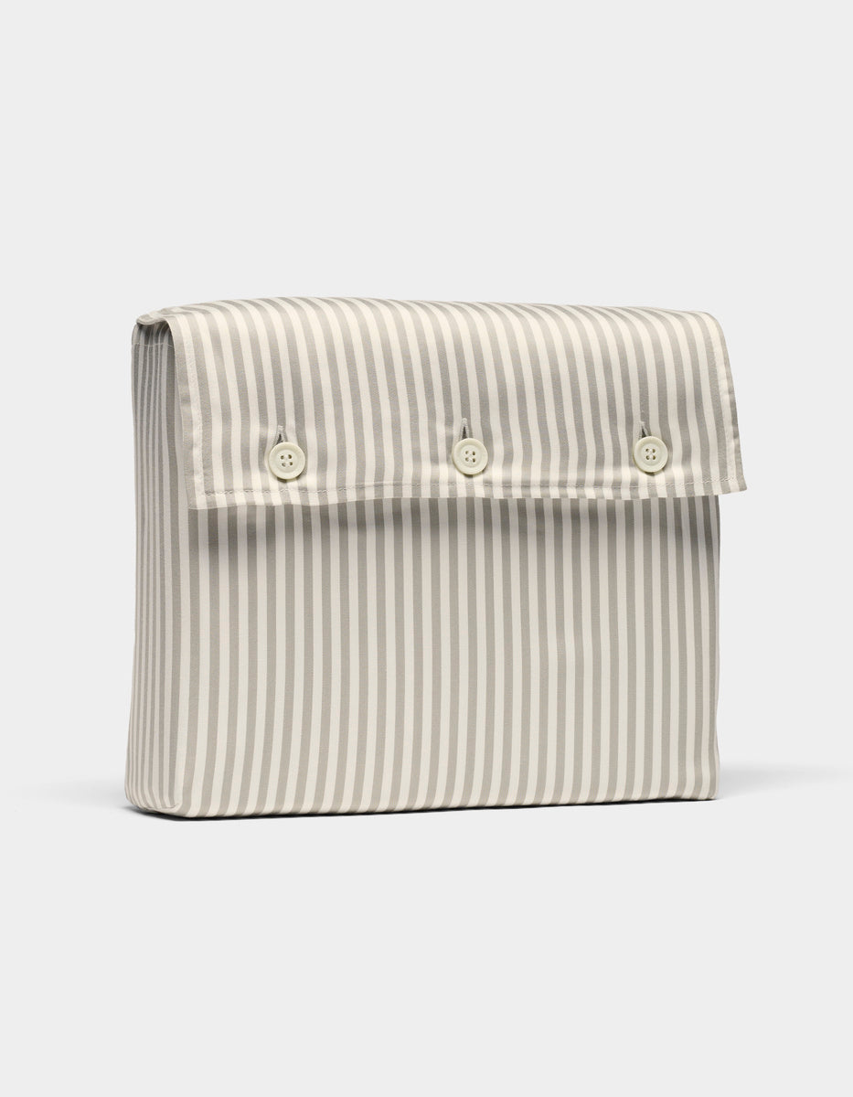 The Bamboo Sheet Set by Cozy Earth comes in a rectangular pouch with vertical blue and white stripes and a front flap secured by three white buttons.
