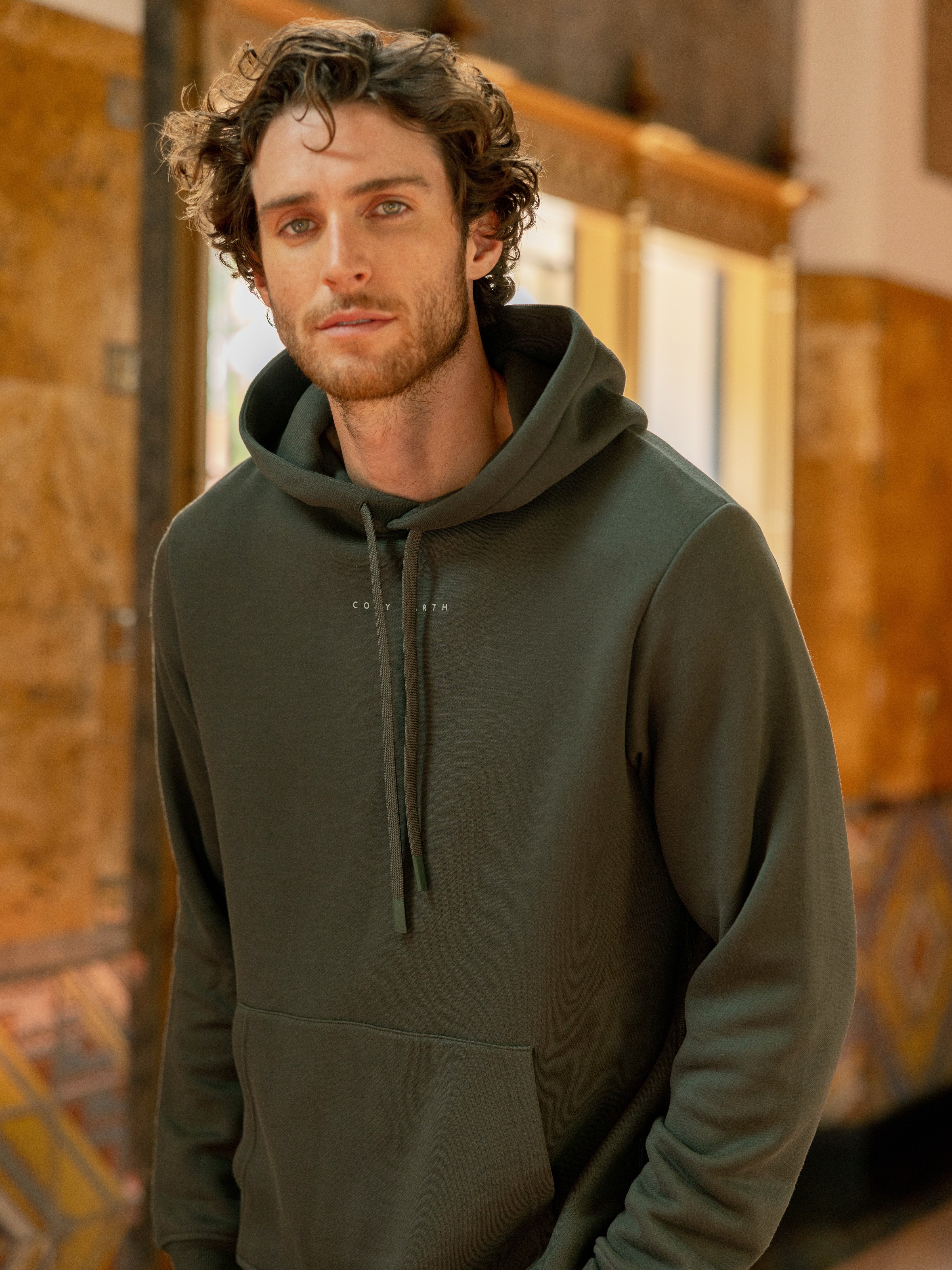 Man wearing storm cityscape hoodie inside building |Color:Storm