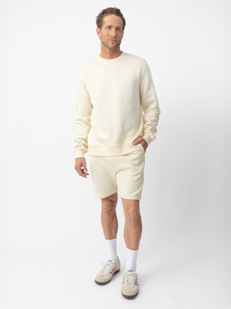 Man wearing Alabaster cityscape crewneck with white background