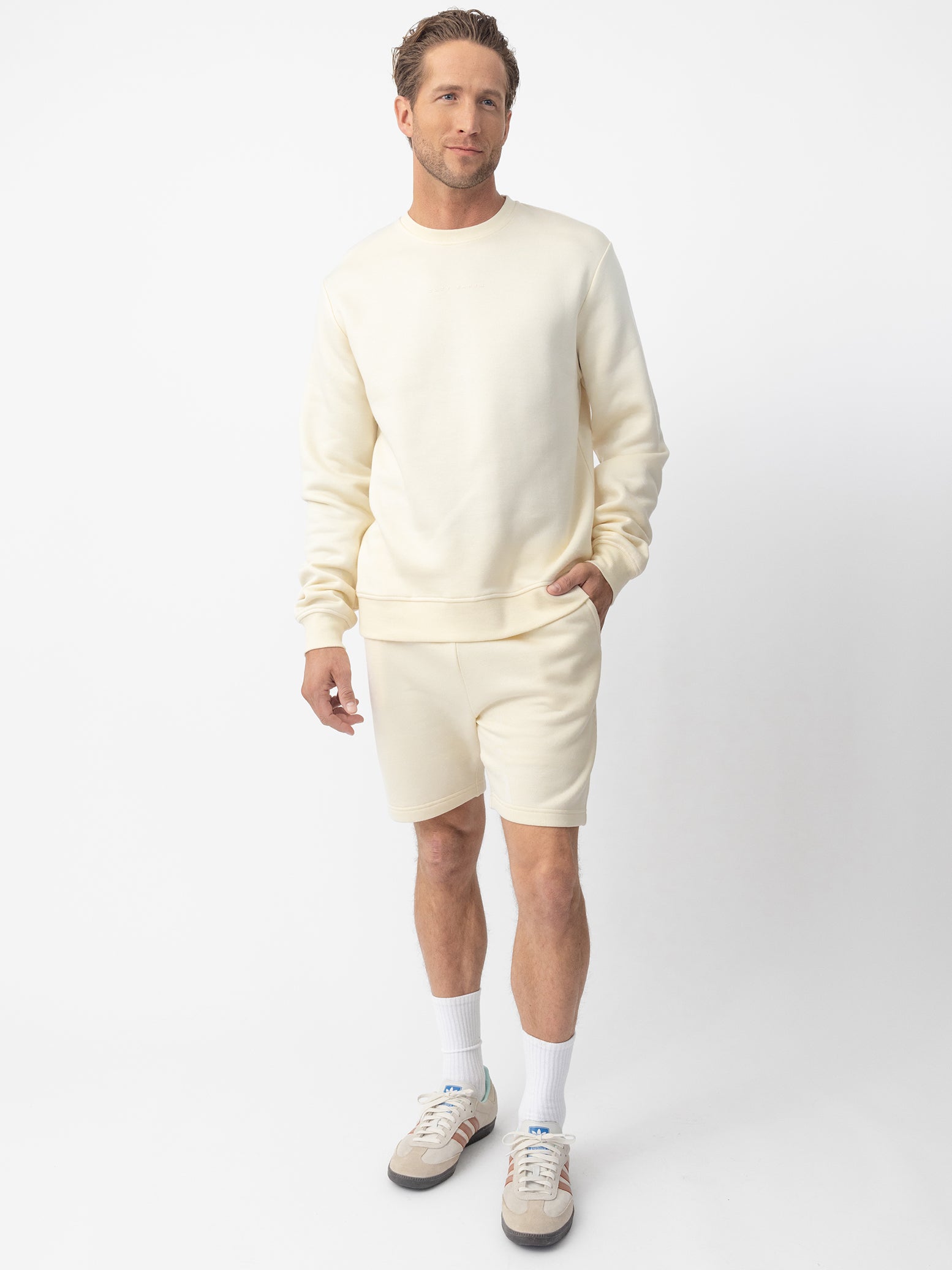 Man wearing Alabaster CityScape Shorts with white background 