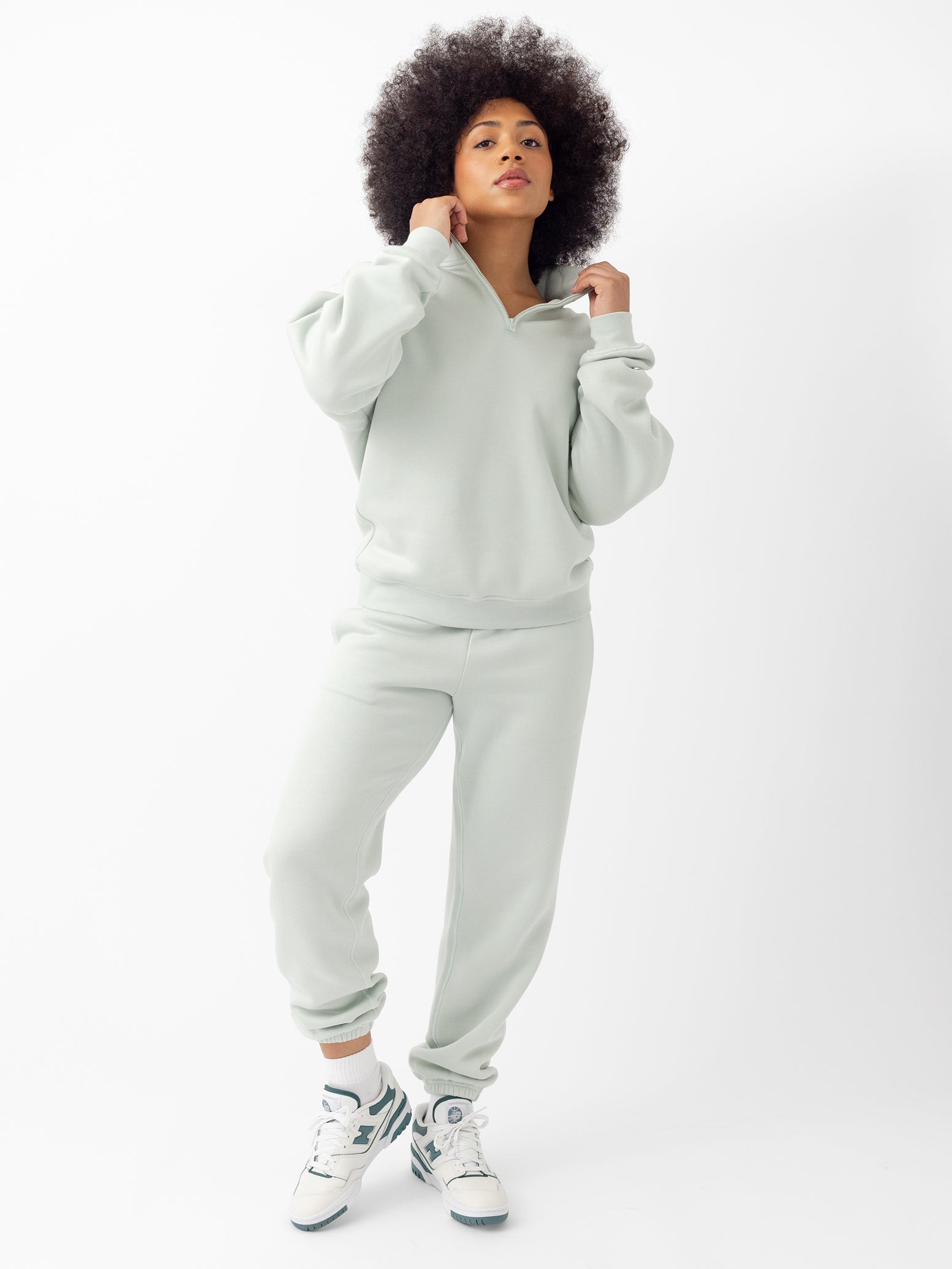 Arctic CityScape Joggers. The Joggers are being worn by a female model. The photo is taken with the models hand by the pocket of the joggers. The back ground is a crisp white background. |Color:Arctic