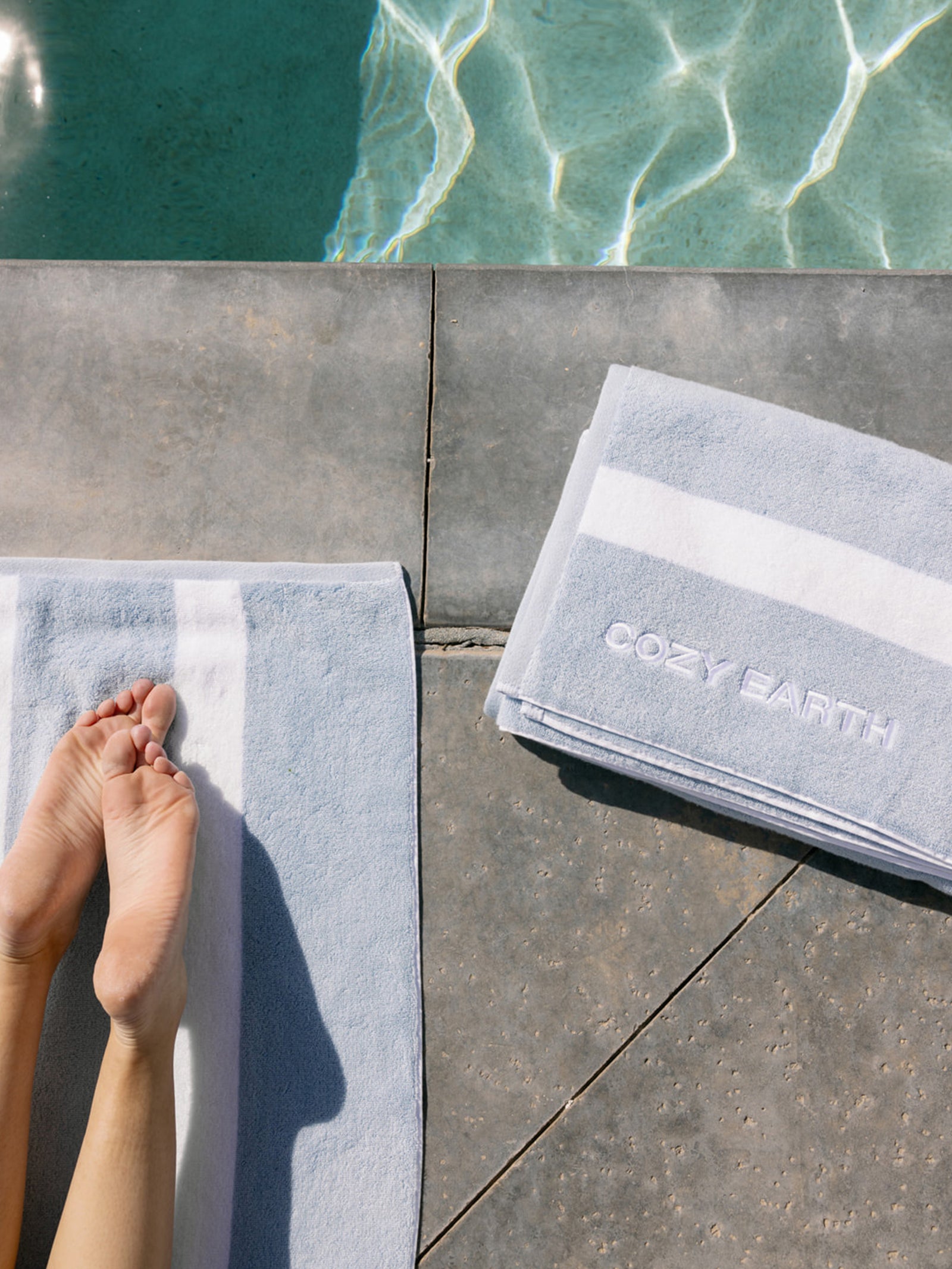 Two Cozy Earth breeze resort towels next to the pool 