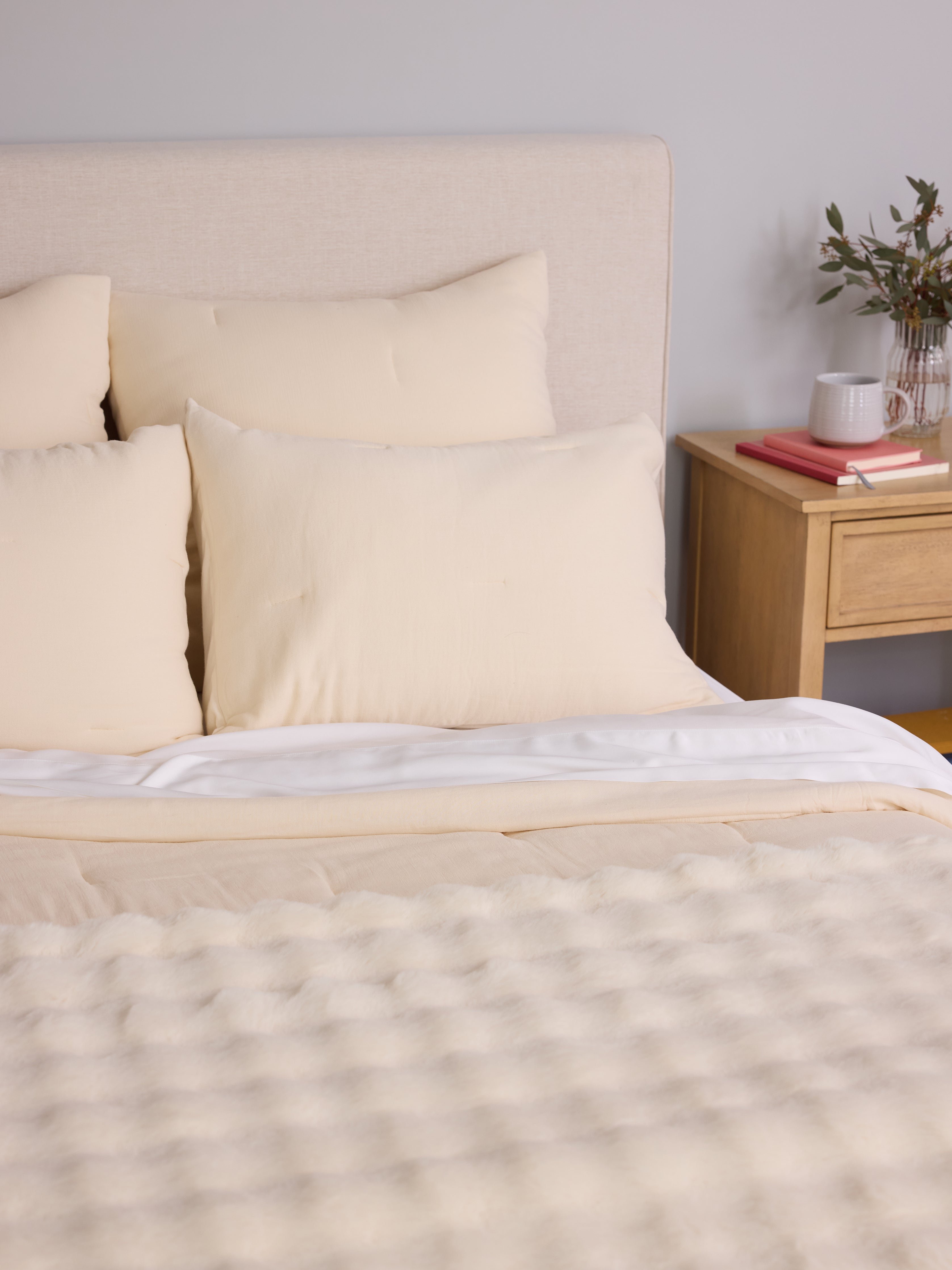 Buttermilk Aire Bamboo Puckered Shams. The sham is resting on a bed in a bedroom|Color:Buttermilk|Size:Standard
