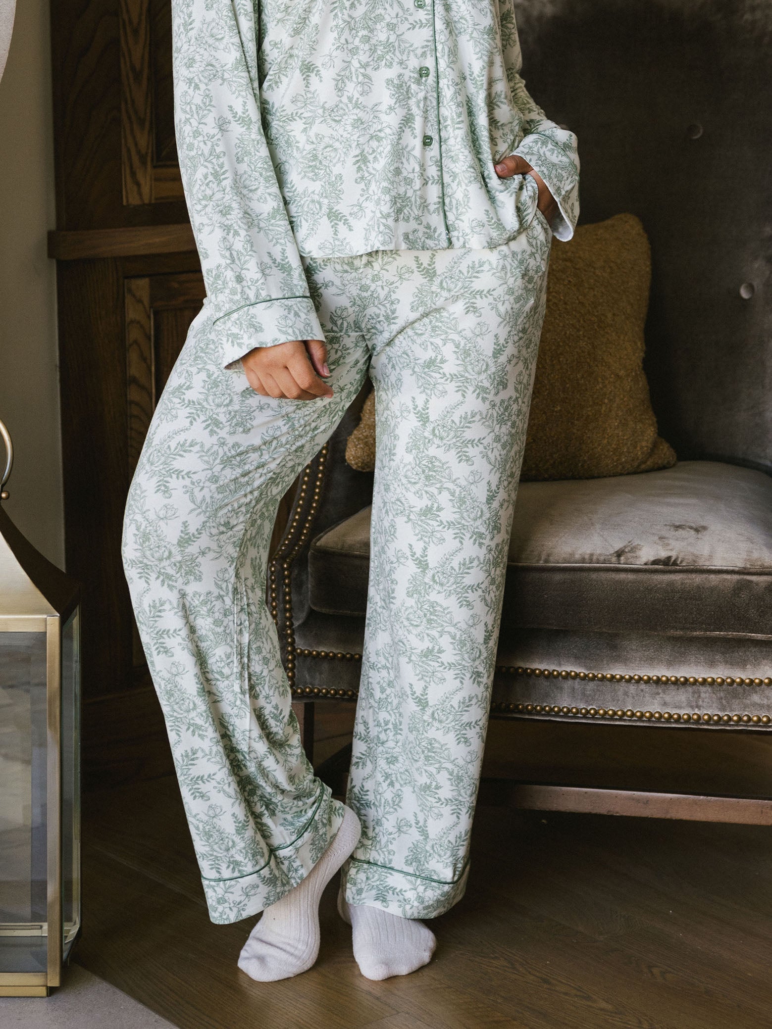 Woman standing in living room in celadon toile pajama pants 