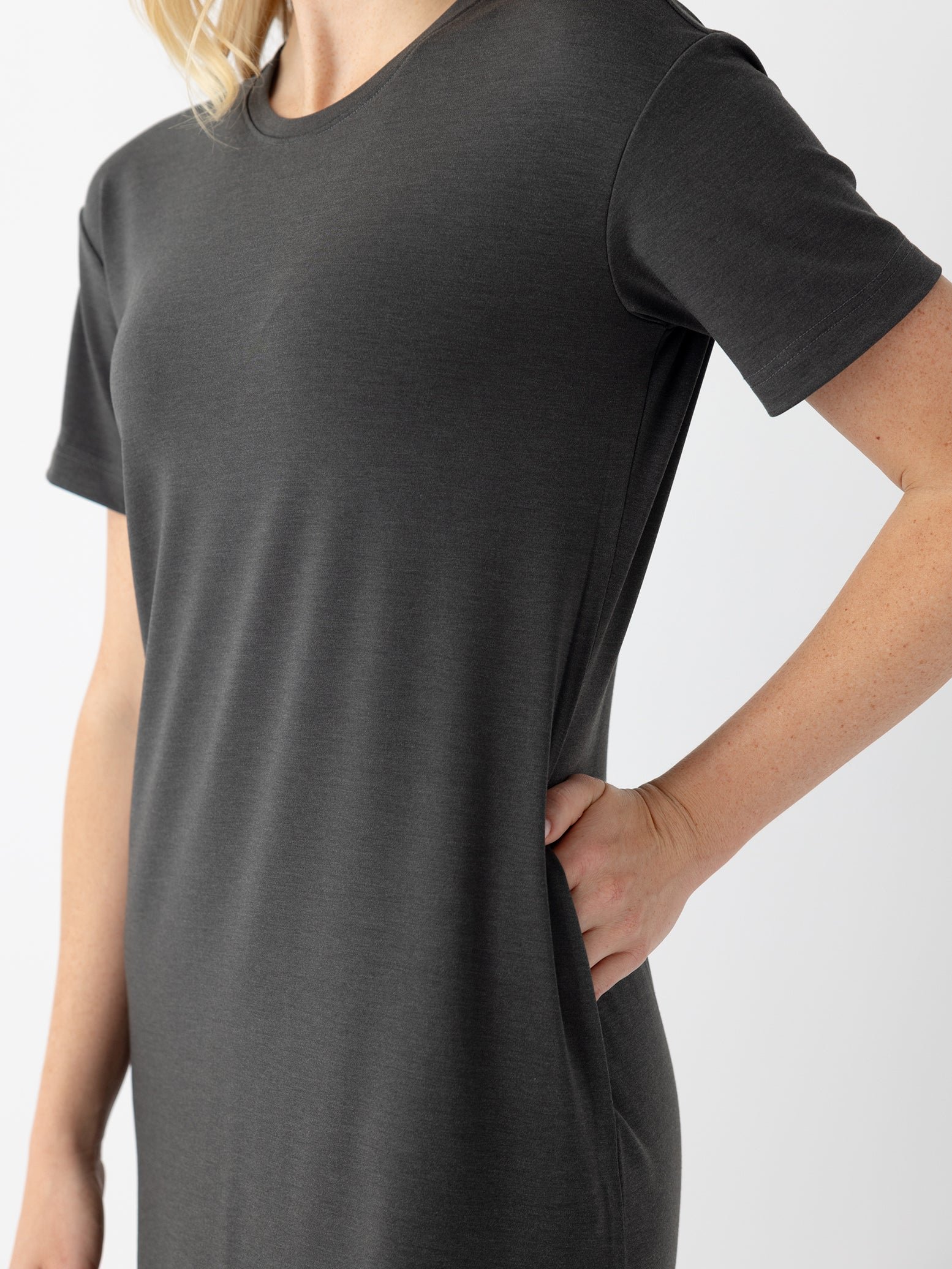 Close up of woman in charcoal midi dress with white background 