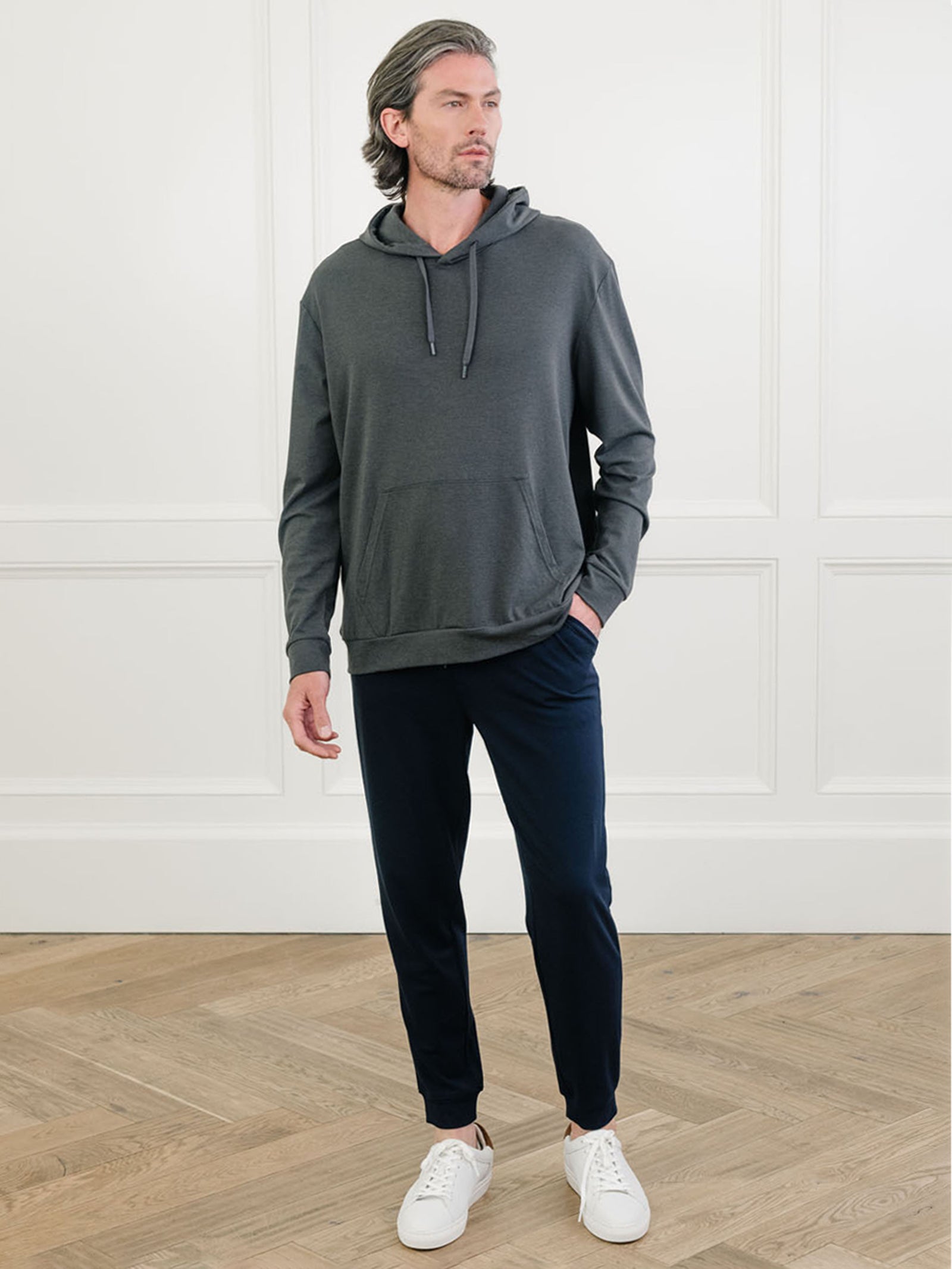 Charcoal Bamboo Hoodie worn by man standing in front of white background.