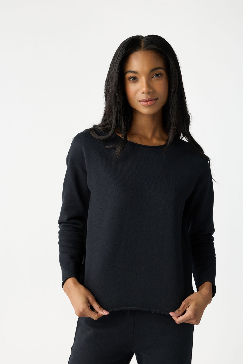 A dark haired woman wears Cozy Earth Women's Chelsea Pullover in Jet Black. |Color:Jet Black