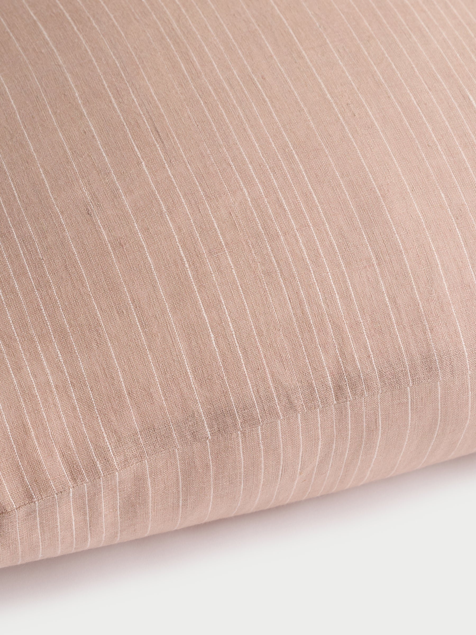 Cozy Earth striped throw pillow with plain white background 