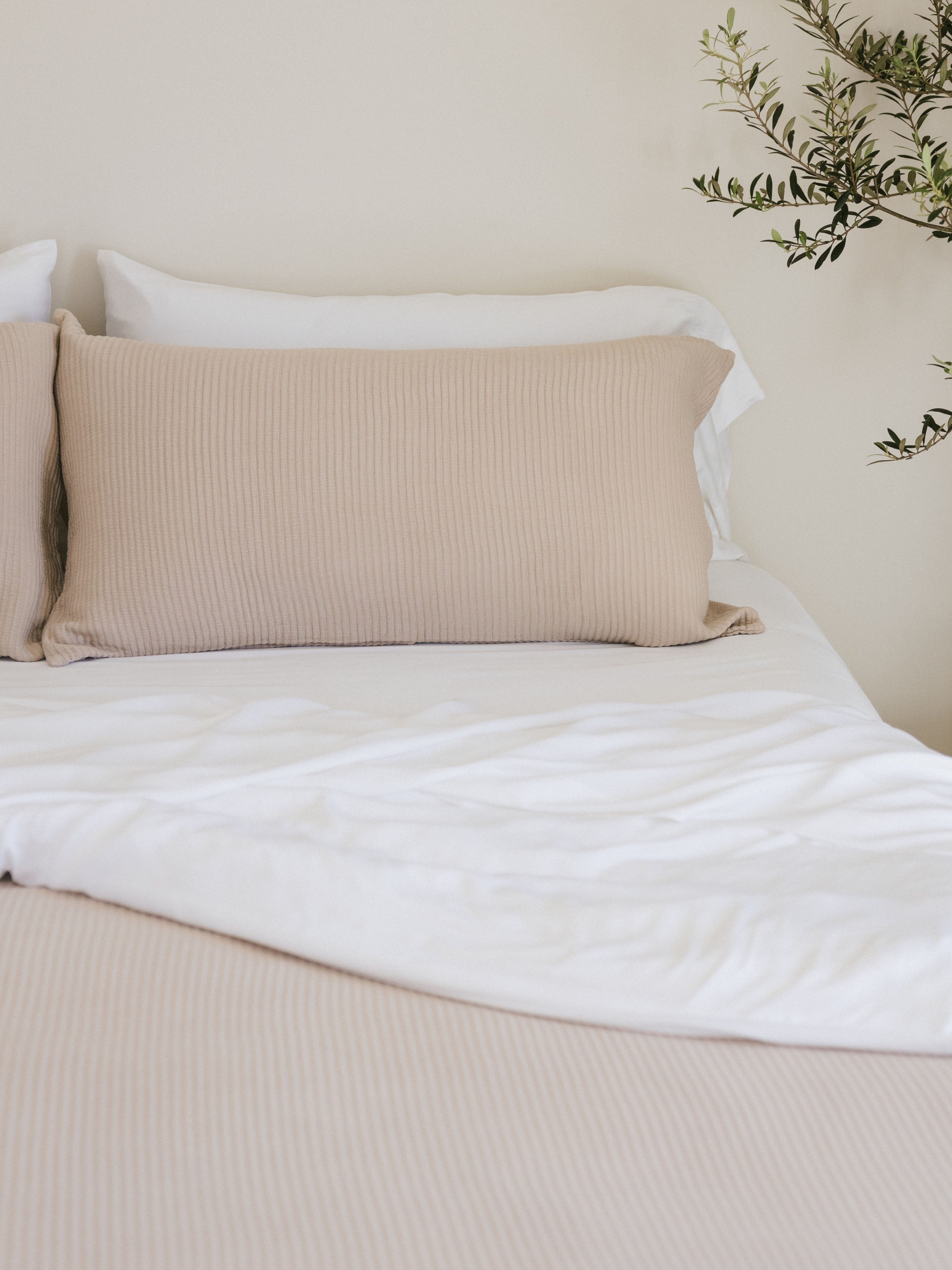 Driftwood coverlet and coverlet shams on white bed 