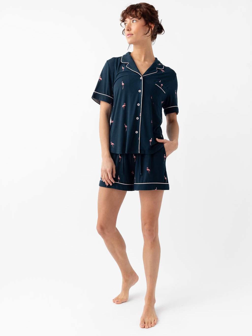 Woman wearing short sleeve flamingo print pajama set with white background 