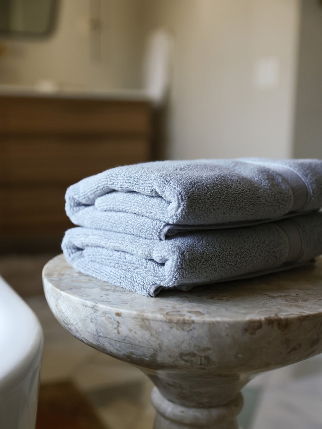 Harbor mist luxe hand towels folded on small table 