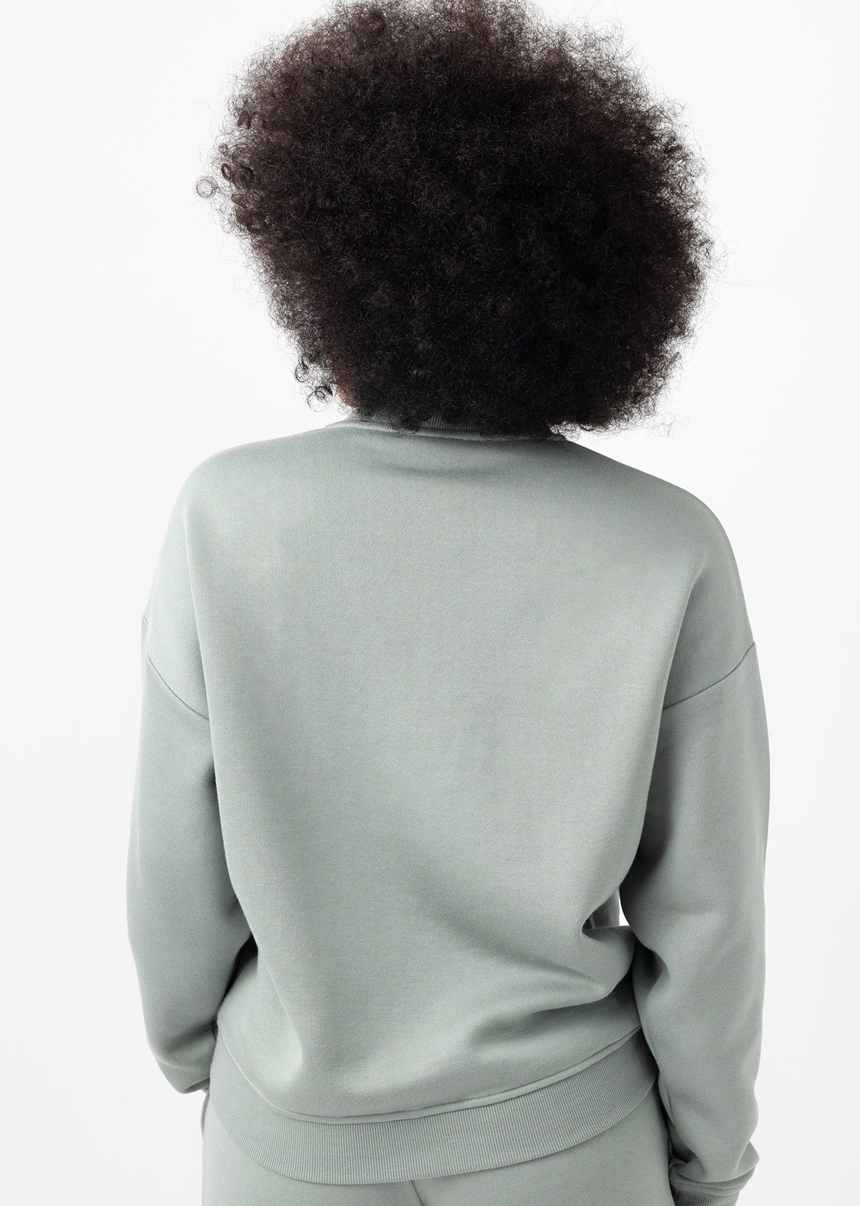 Back of woman wearing haze cityscape pullover 