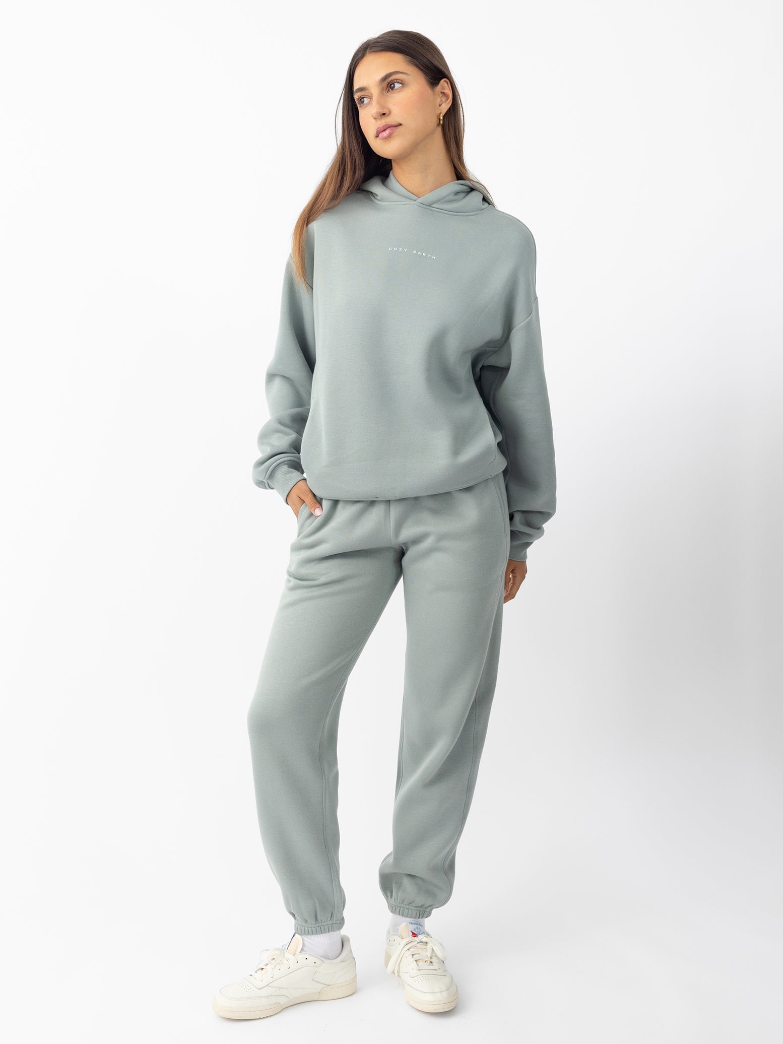 Woman wearing haze cityscape hoodie and sweats with white background 