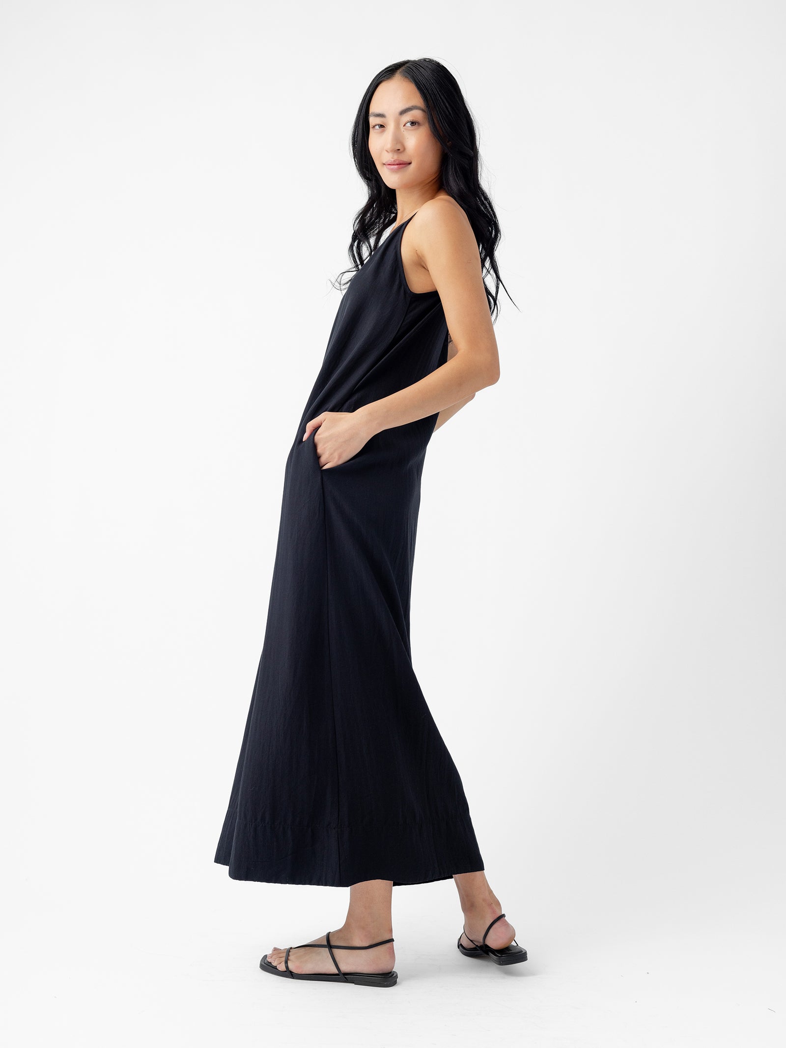 A woman in Cozy Earth's Women's Sunset Slip Dress. 