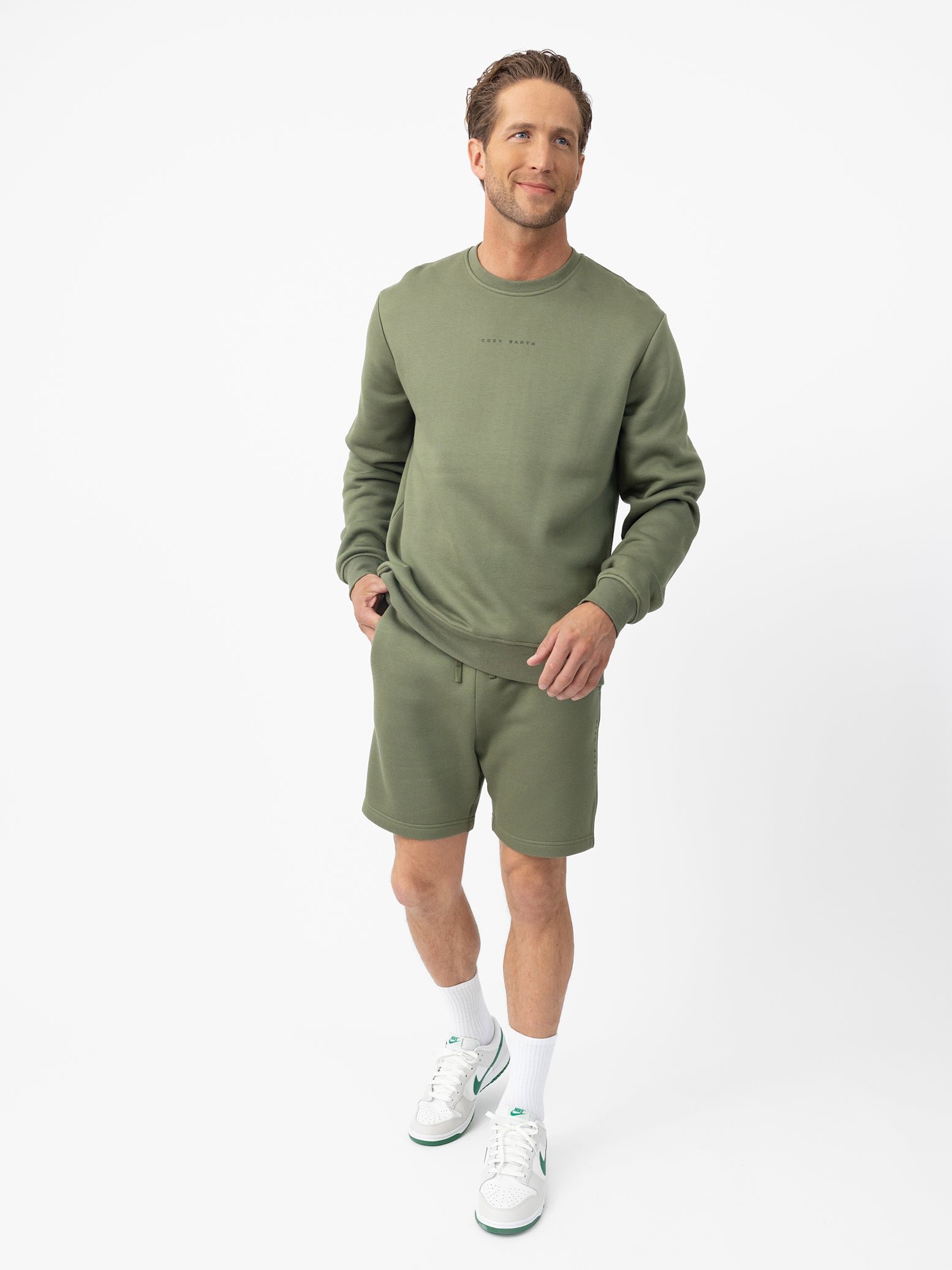 Man wearing Juniper cityscape crewneck with white background 