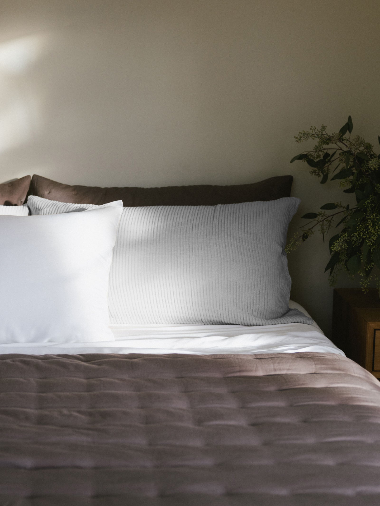 Light Grey coverlet sham on bed with charcoal linen puckered quilt 