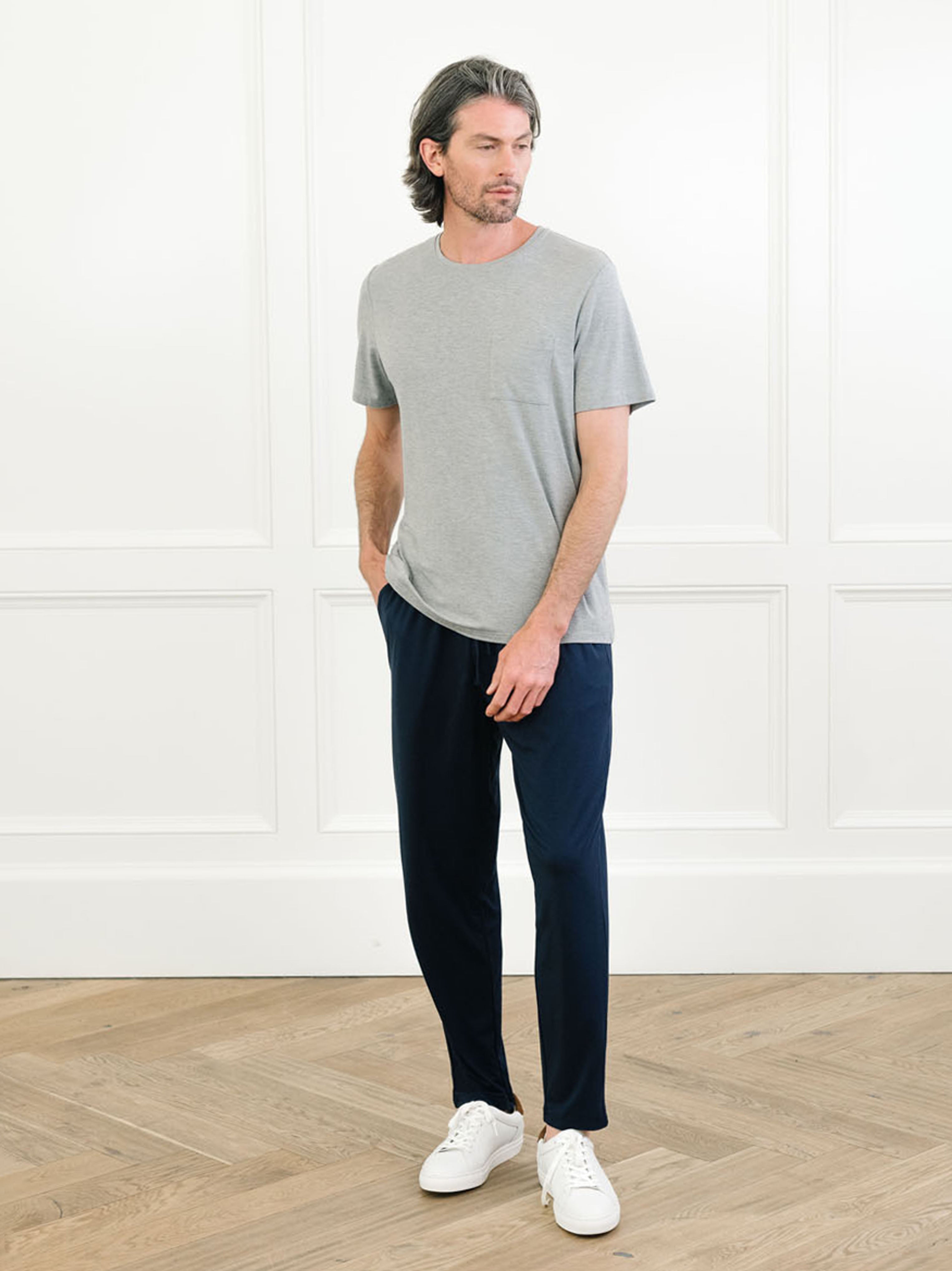 Heather Grey Men's Stretch-Knit Bamboo Lounge Tee. A man is wearing the lounge tee in a well lit home.|Color:Heather Grey