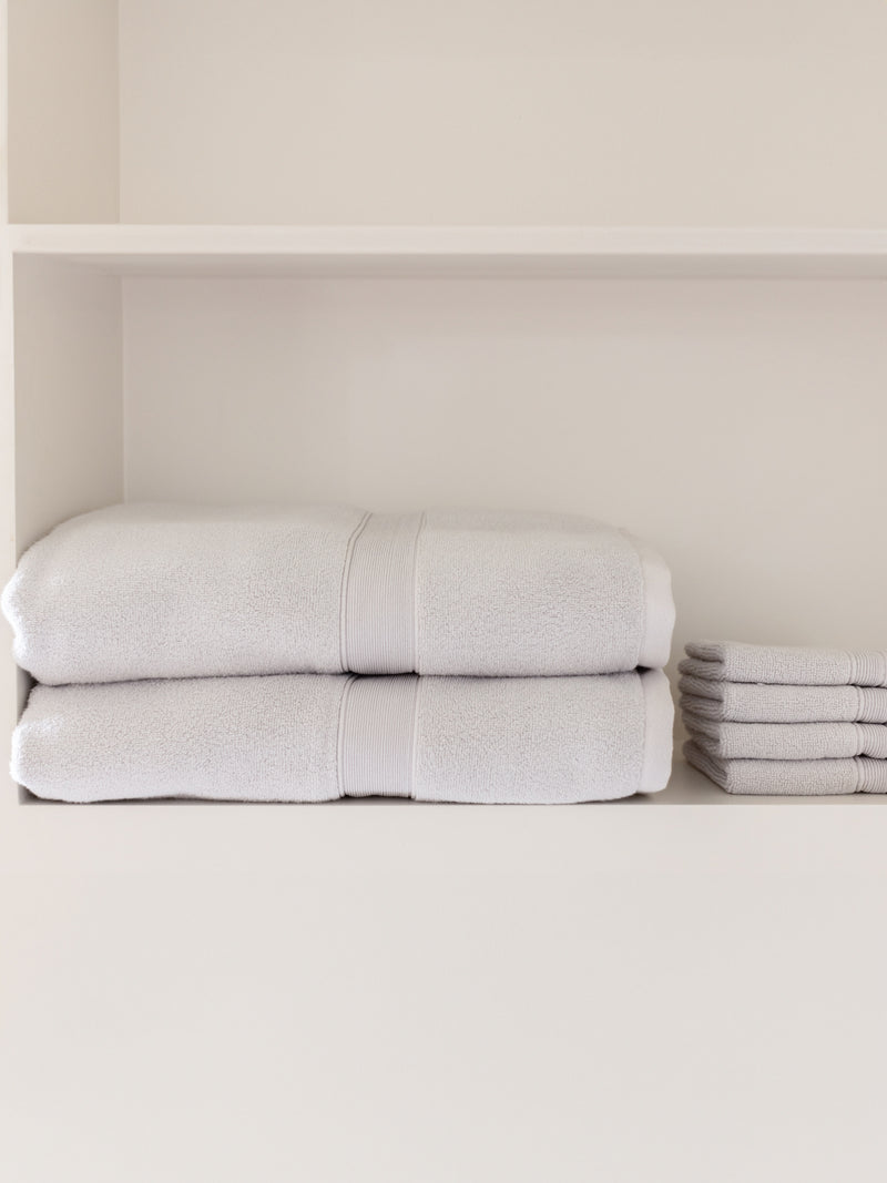 Light grey luxe bath sheets and washcloths on shelf