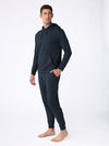 A man stands barefoot against a white background, wearing the Cozy Earth Men's Brushed Bamboo Hoodie & Jogger Set with his left hand in his pocket. |Color:Navy
