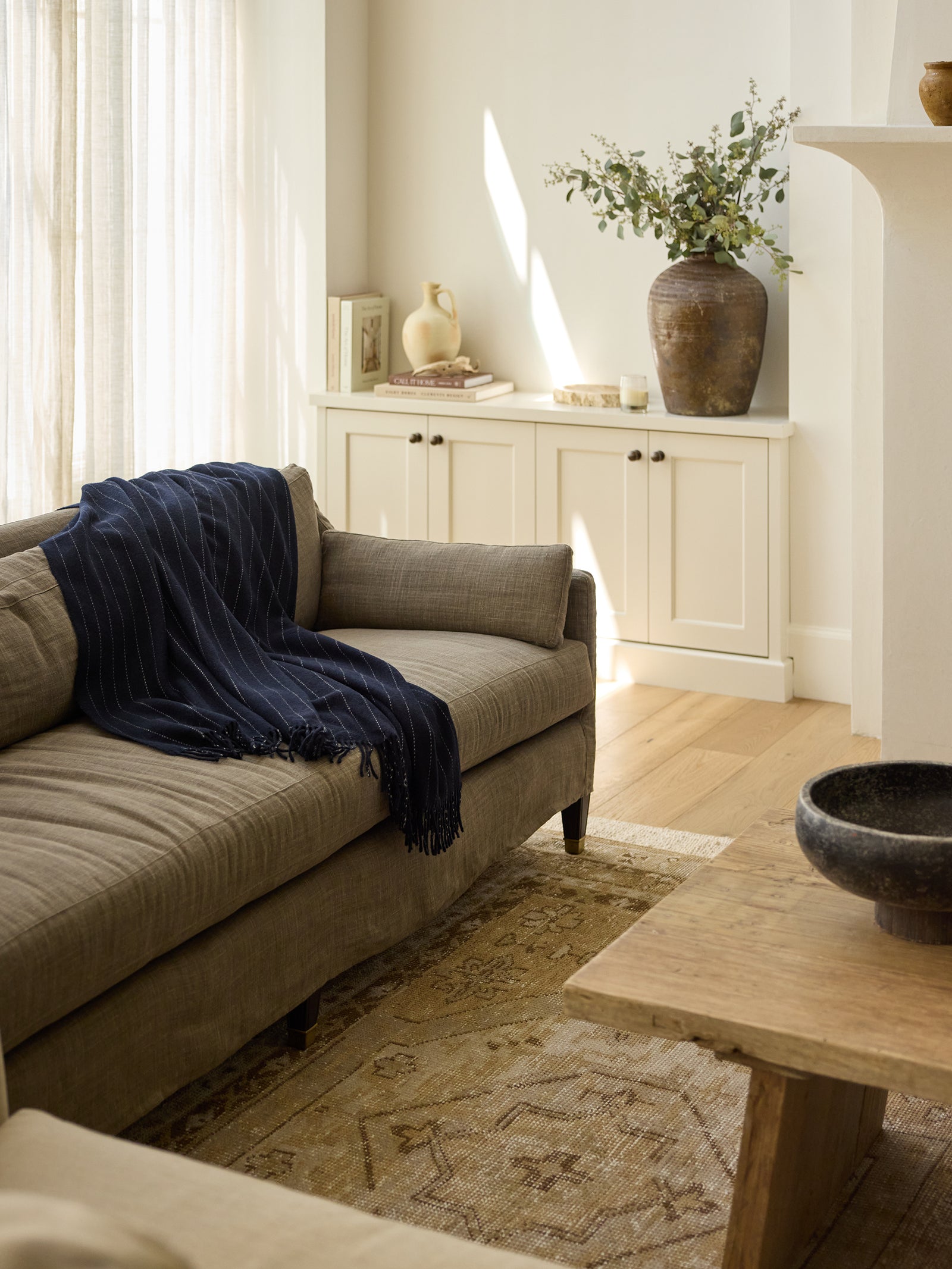 Living room with navy florence throw draped over the sofa 