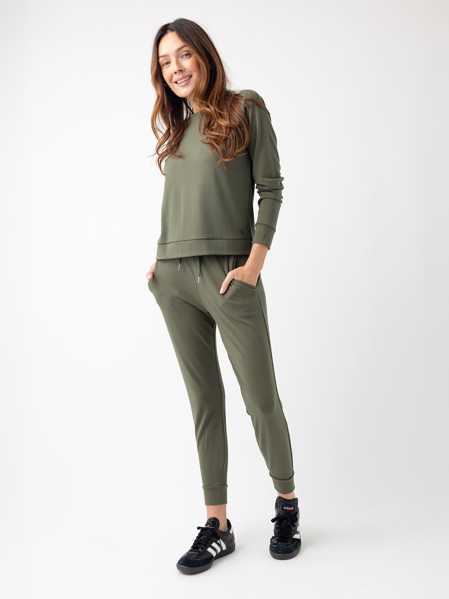 Woman in olive jogger set with white background 
