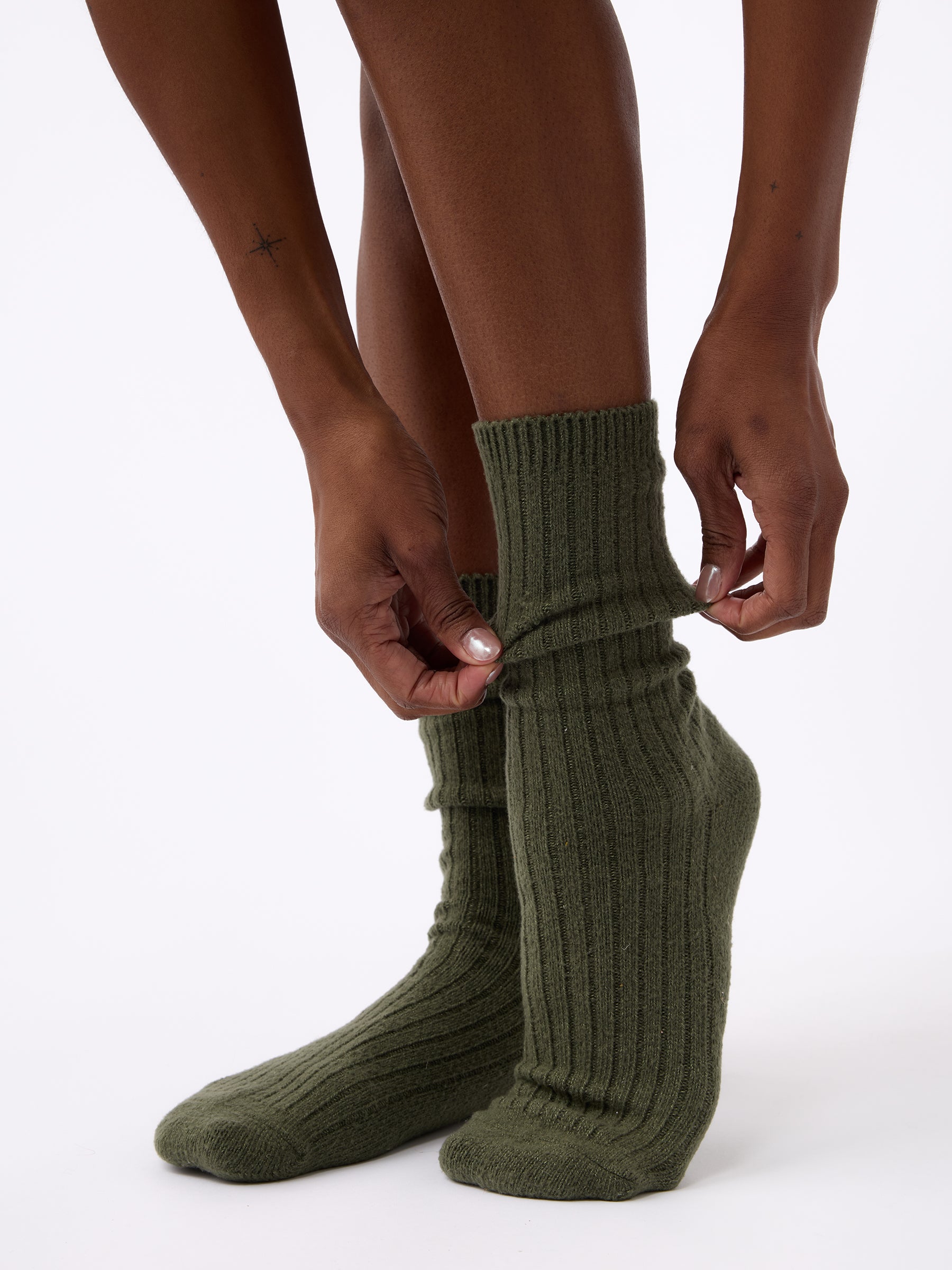 Person wearing Cozy Earth Plush Lounge Sock 1-Pack in Olive |Color:Olive