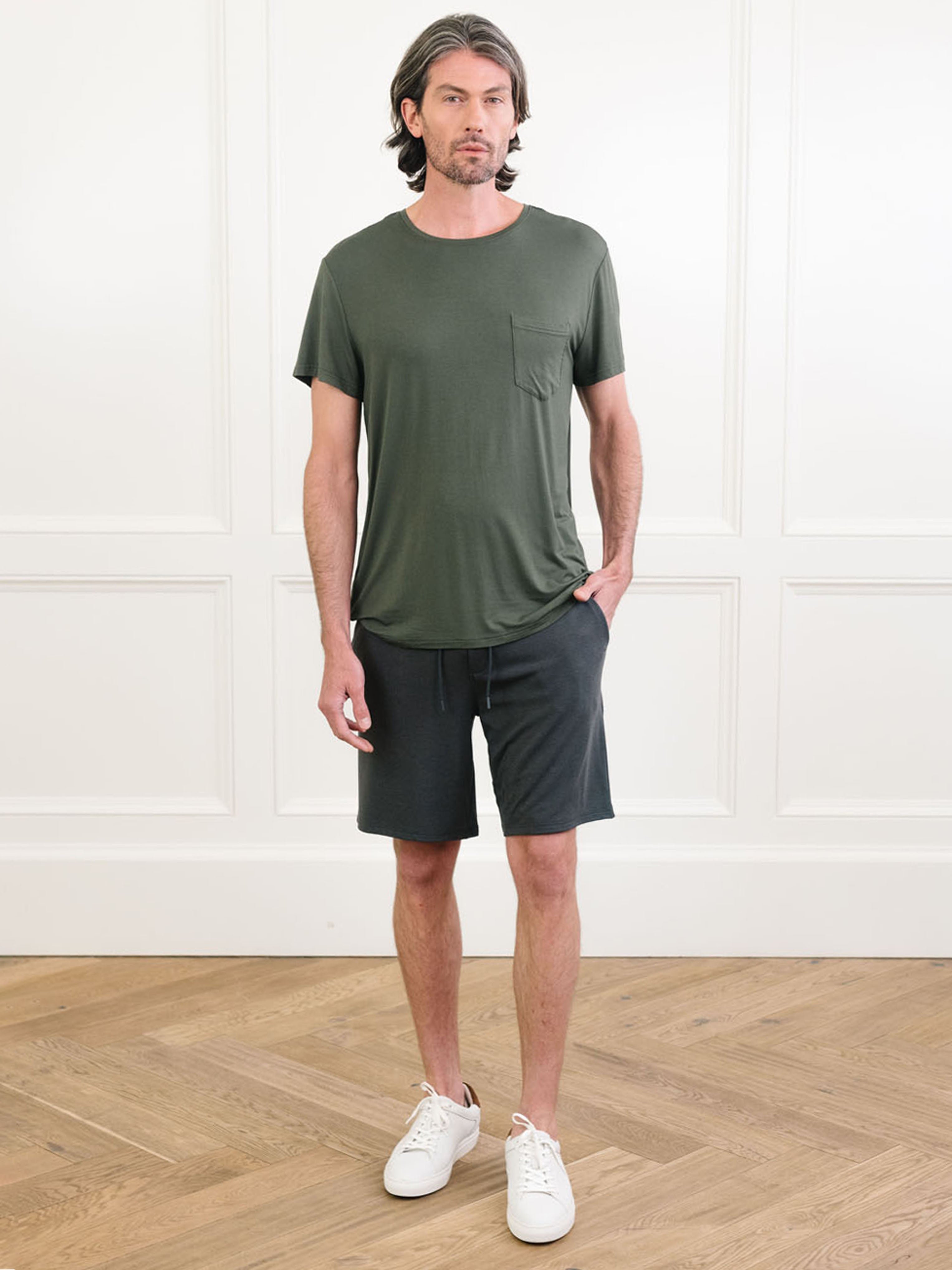 Olive Men's Stretch-Knit Bamboo Lounge Tee. A man is wearing the lounge tee in a well lit home.