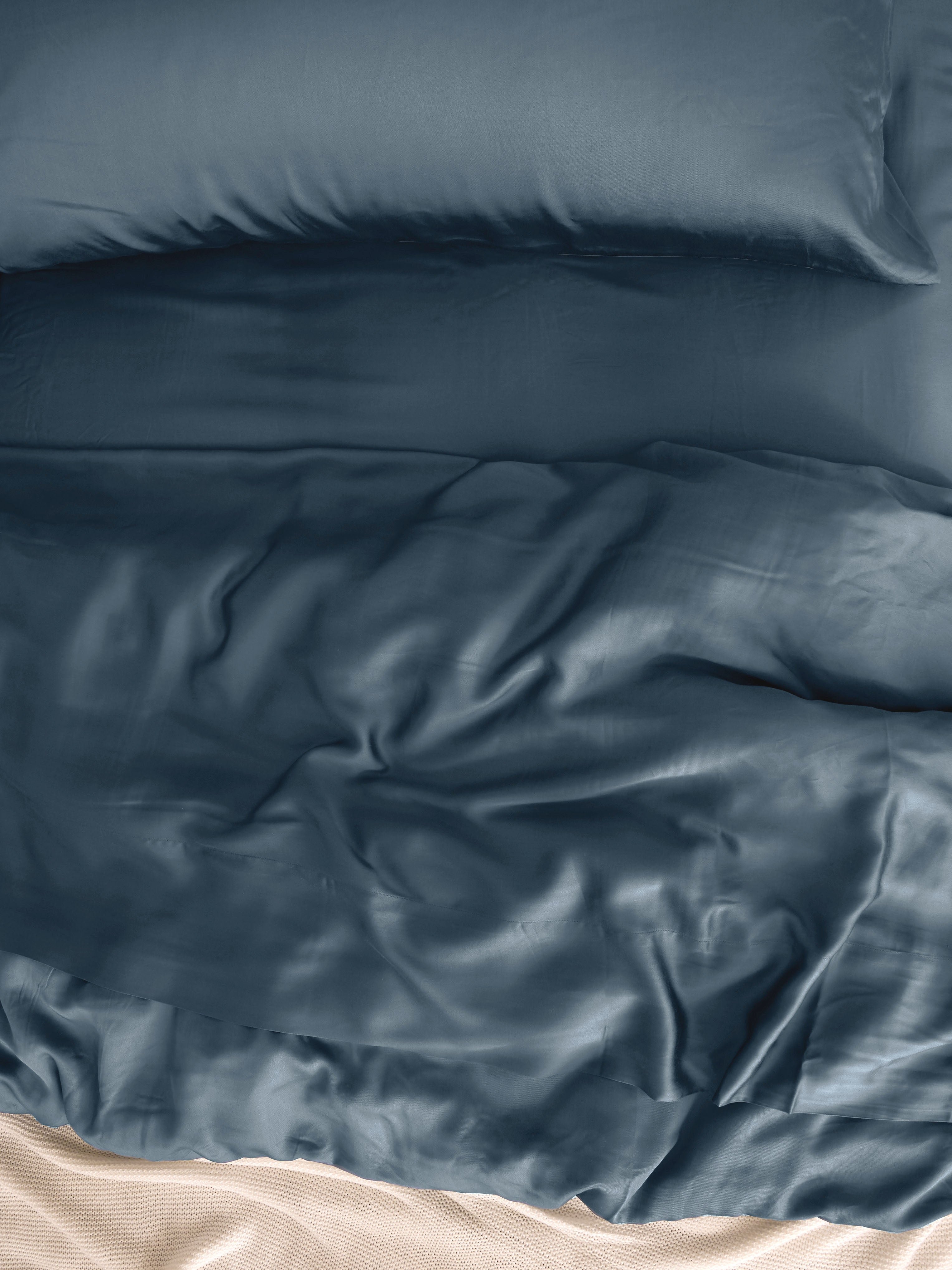 Close up of bed with pacific blue bedding 