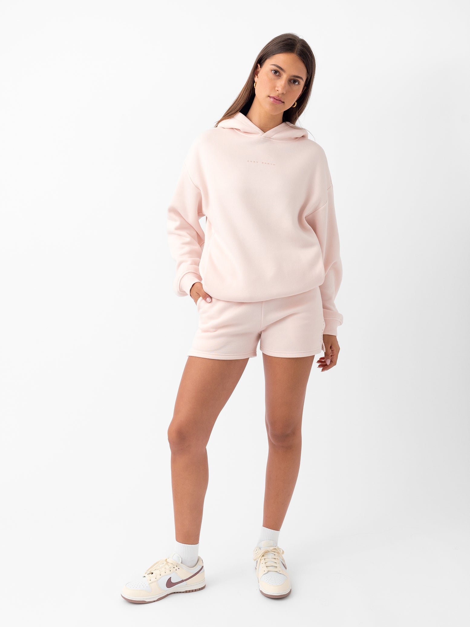 Peony CityScape Shorts. The shorts are being worn by a female model in casual shoes. The background it a white background. 