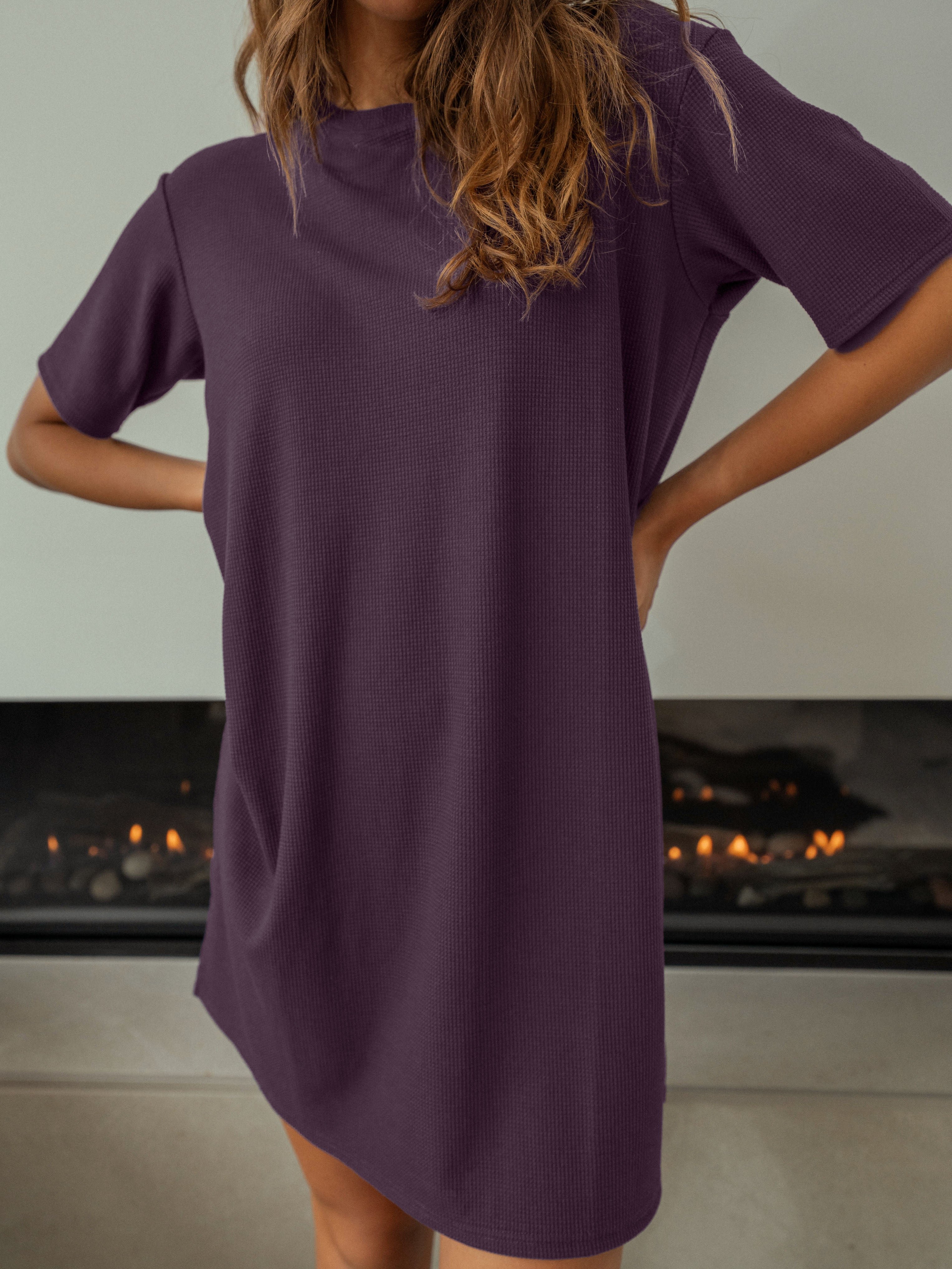 Women wearing a Waffle Knit Dress in front of a fireplace