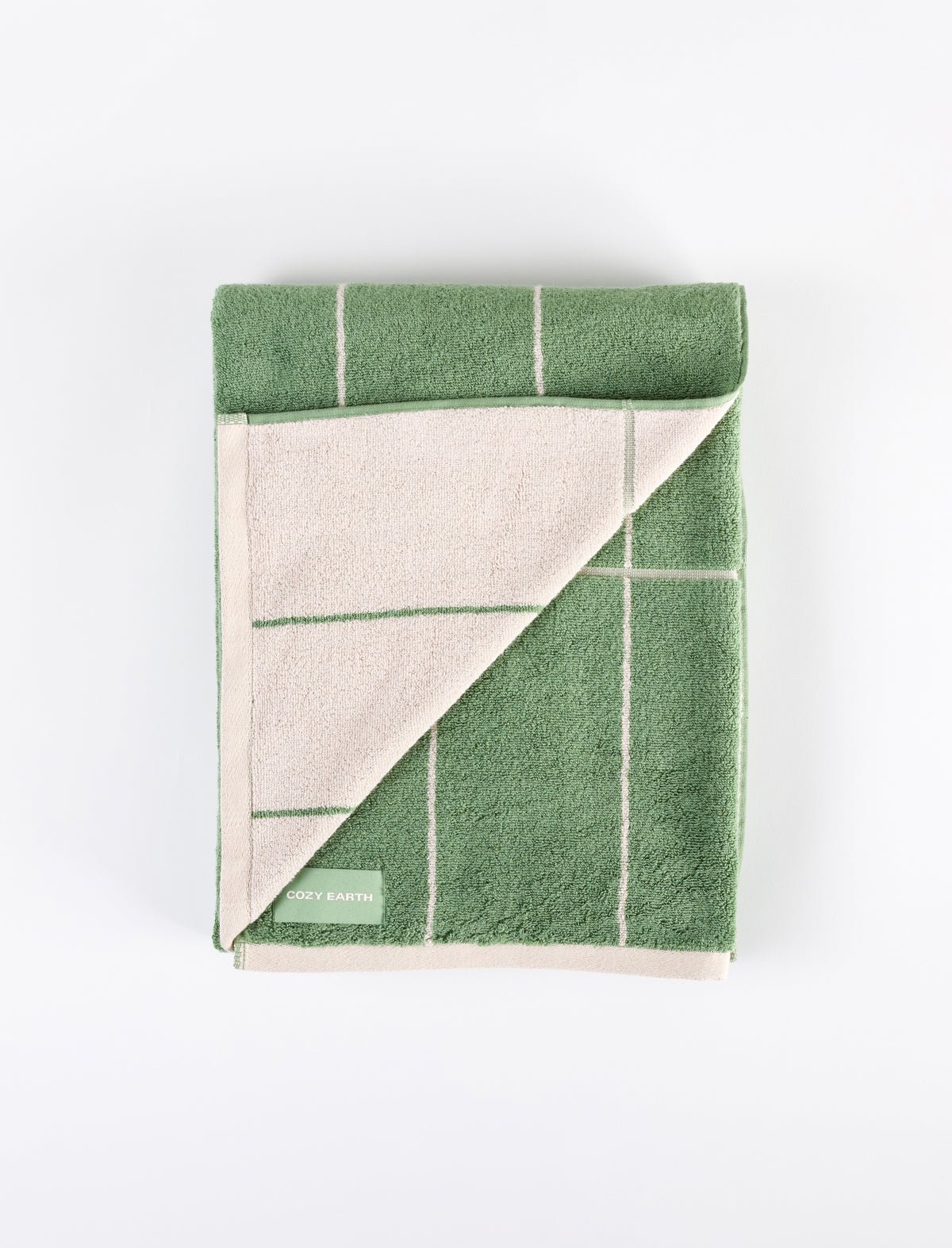 A green Windowpane Resort Towel with cream grid lines and a cream underside, one corner flipped to show the back. The "Cozy Earth" label is in the lower left corner, all on a white background. |Color:Prickly Pear