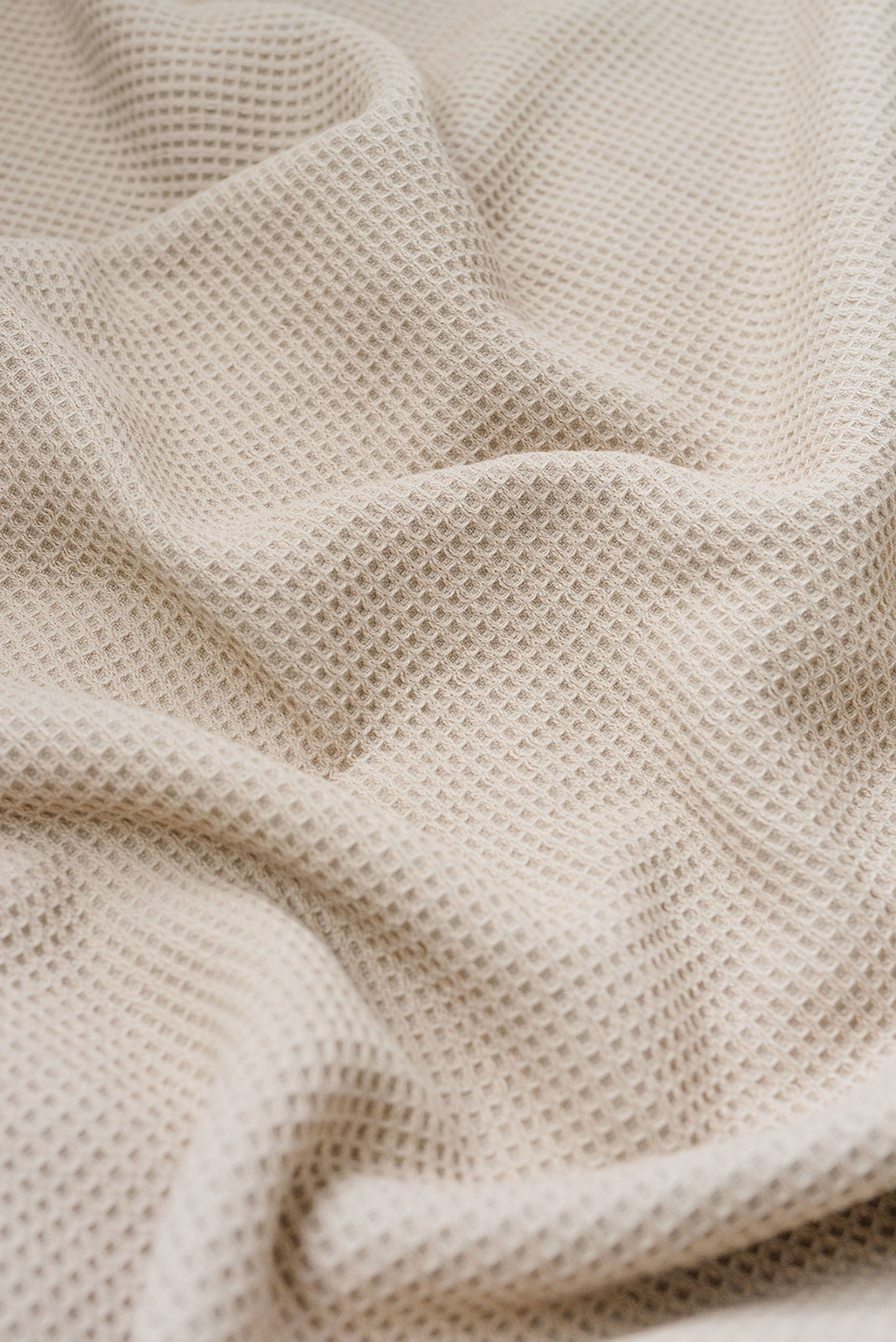 Sand Waffle Hand Towel photographed close up so that the detail of the waffle knit can be seen. 