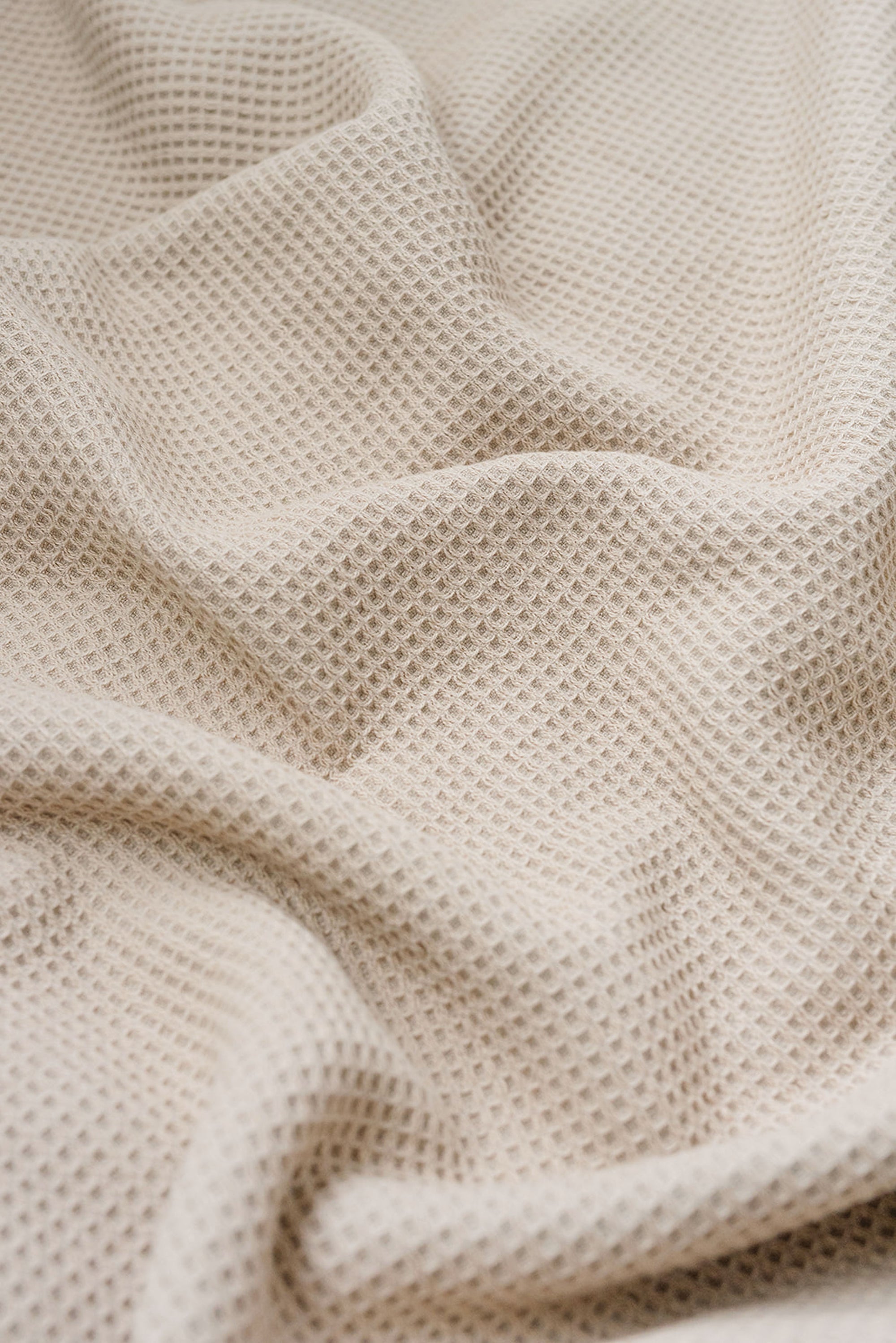 Sand Waffle Hand Towel photographed close up so that the detail of the waffle knit can be seen. 