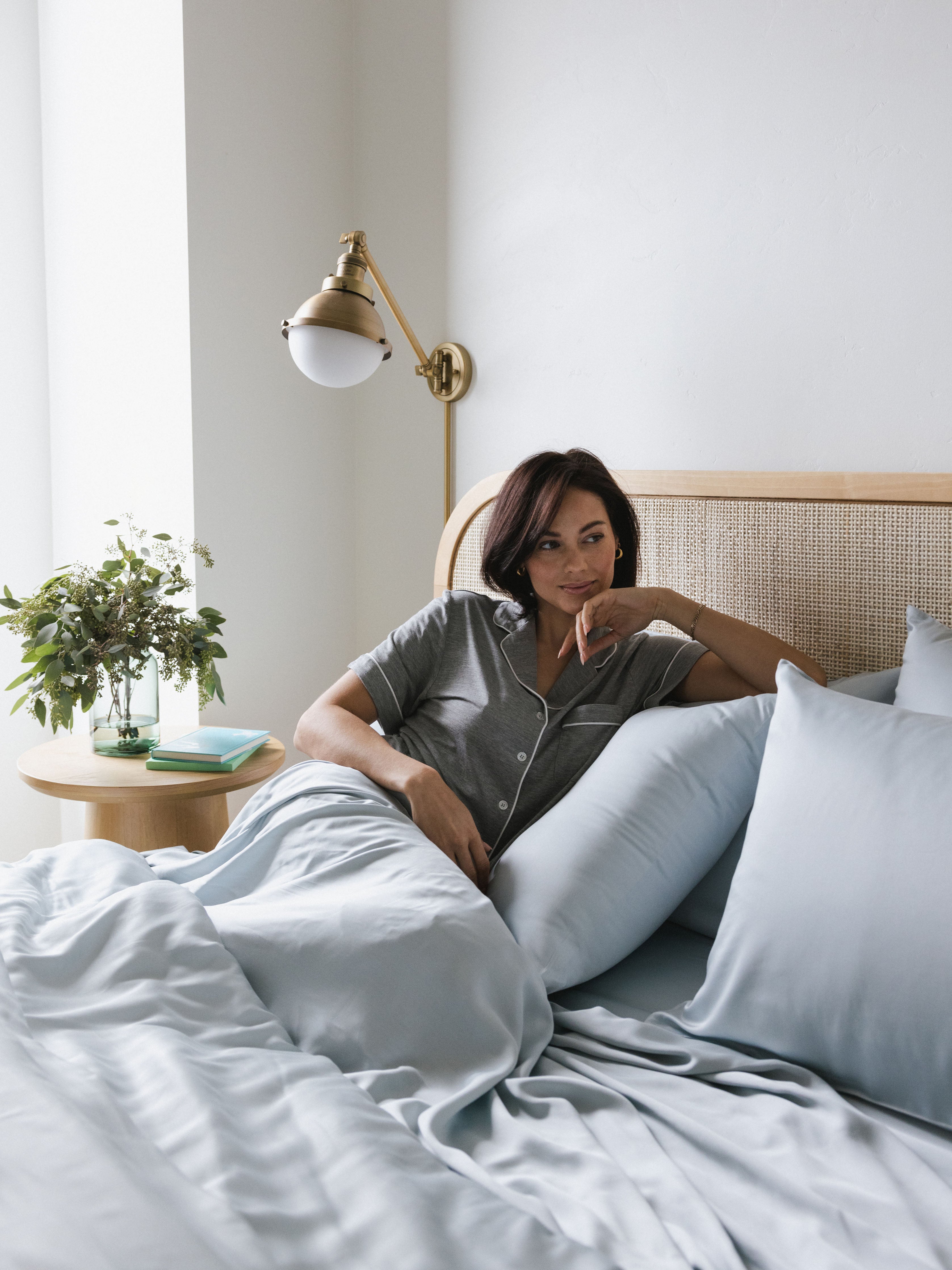 Woman laying in bed with shore bedding |Color:Shore