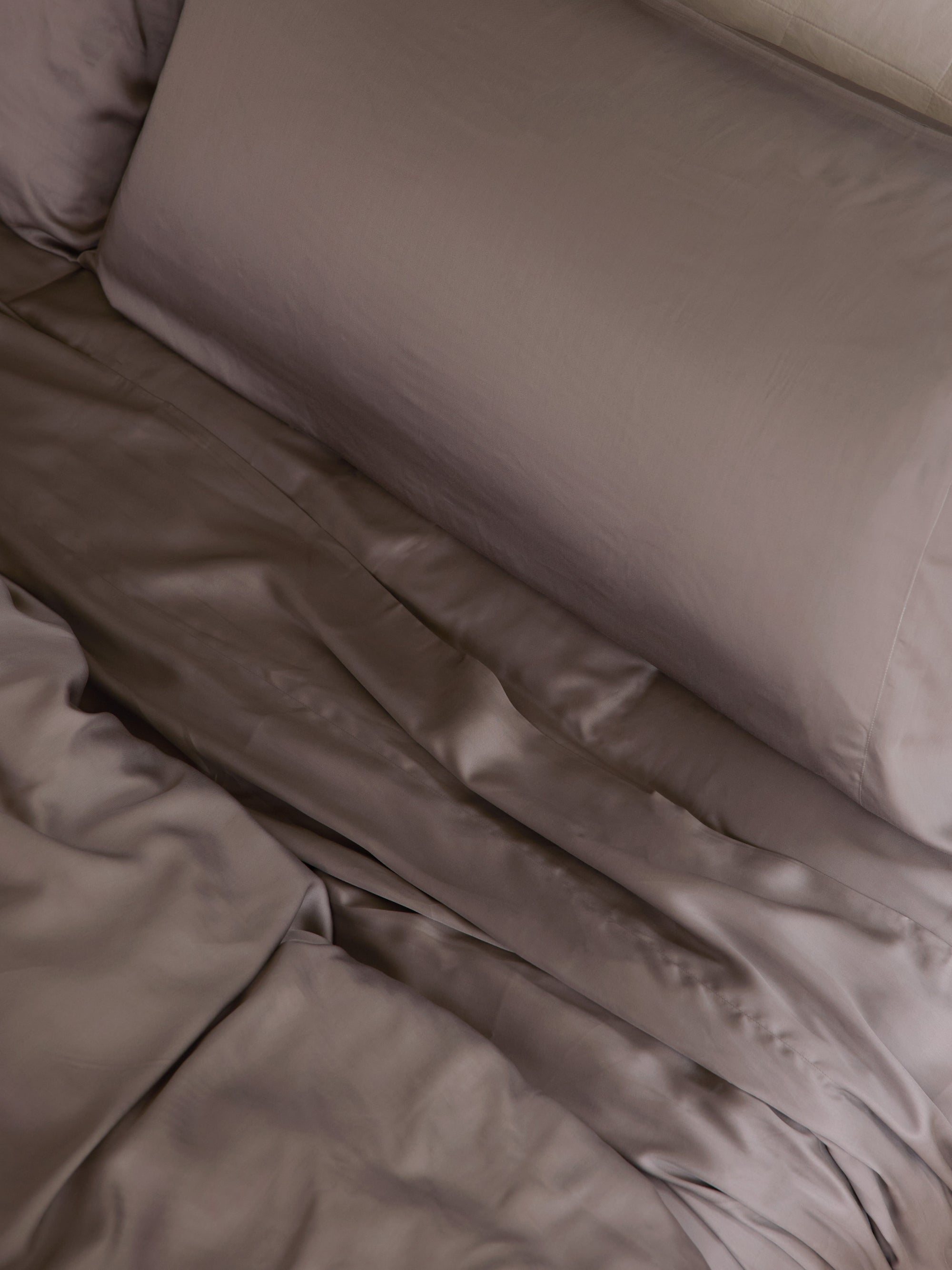 Close up of stone bedding on an unmade bed 