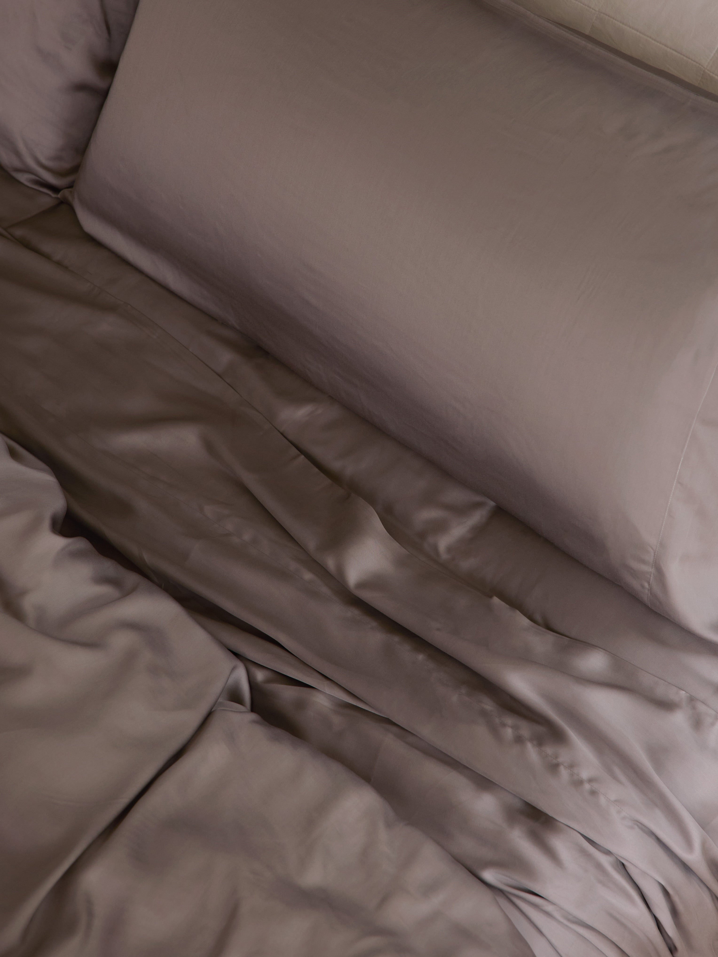 Close up of stone bedding on an unmade bed |Color:Stone